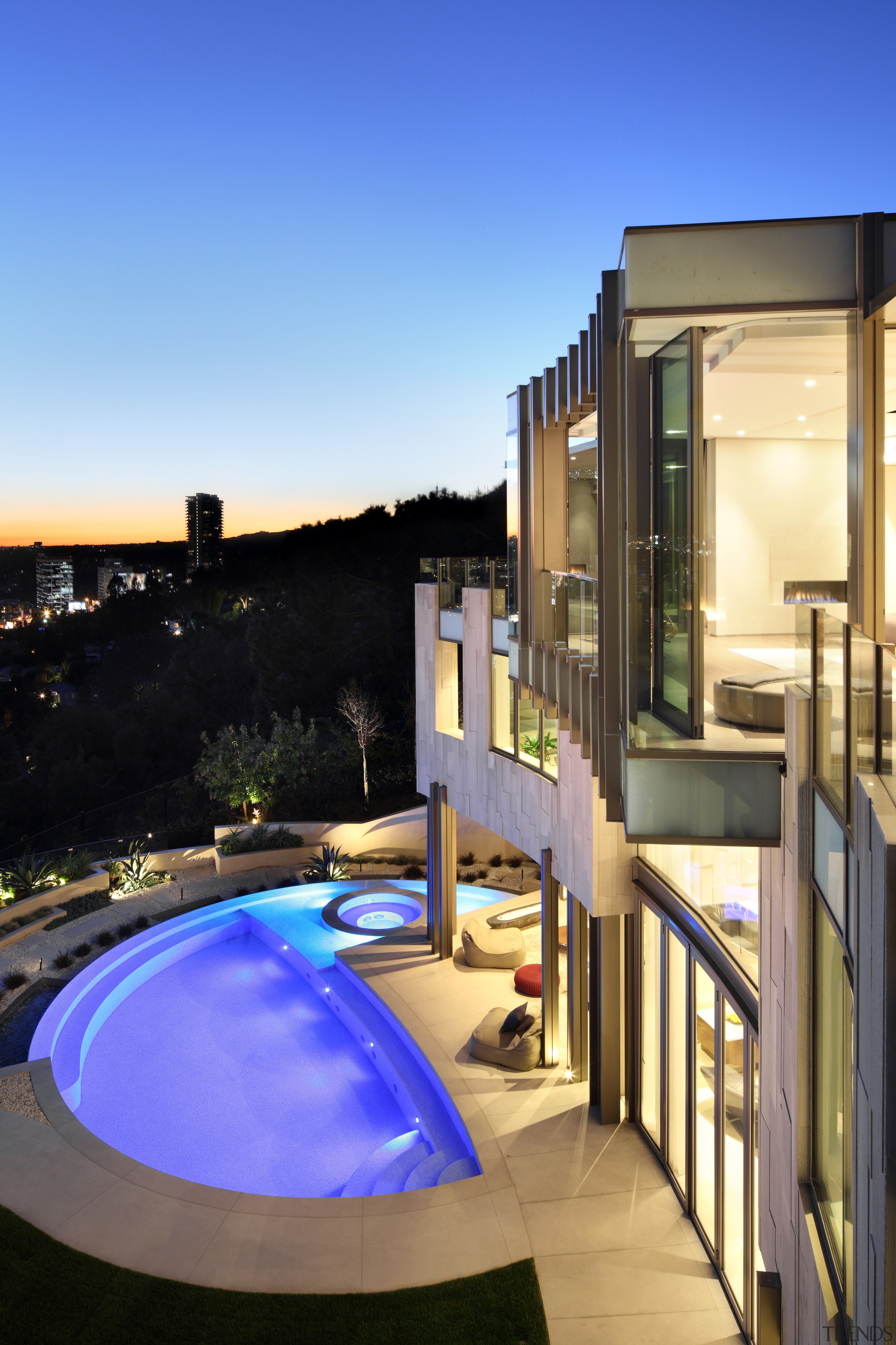 Nearly every surface in this hillside home follows apartment, architecture, estate, home, house, property, real estate, residential area, swimming pool, blue