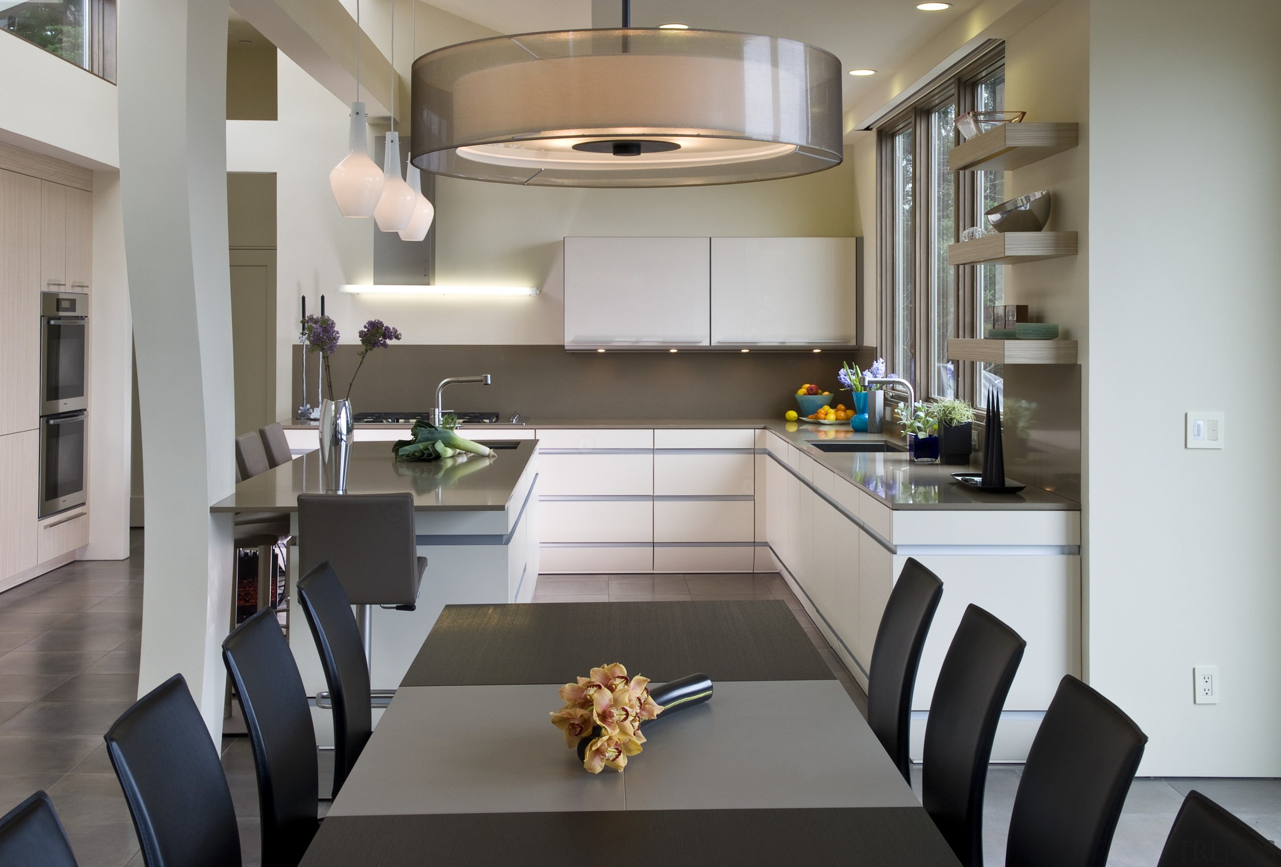 View of neutral-toned kitchen and dining space, featuring countertop, interior design, kitchen, room, gray