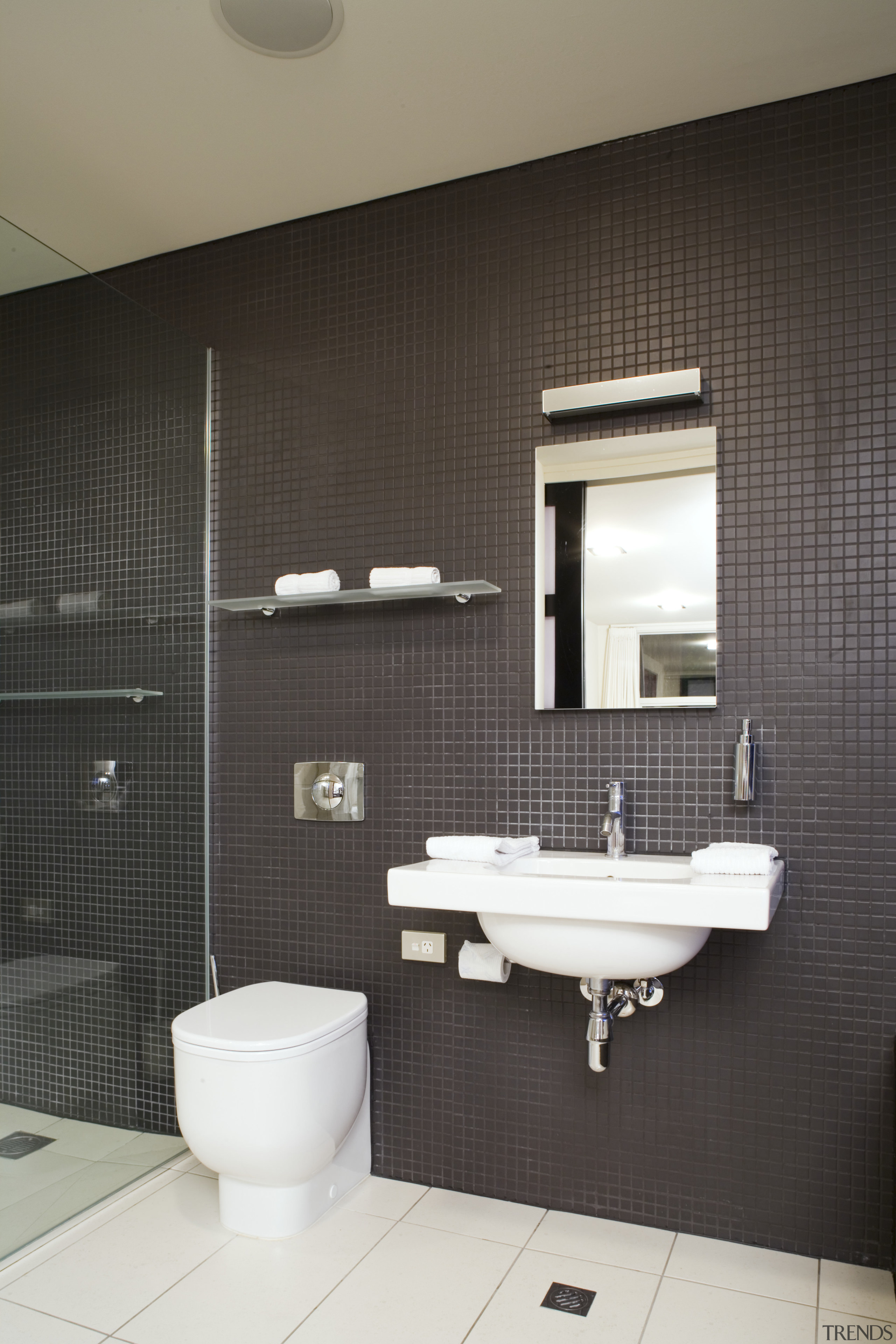 View of ensuite inside master bedroom featuring vanity architecture, bathroom, bathroom accessory, bidet, ceramic, floor, interior design, plumbing fixture, product design, public toilet, room, sink, tap, tile, toilet, wall, black, gray