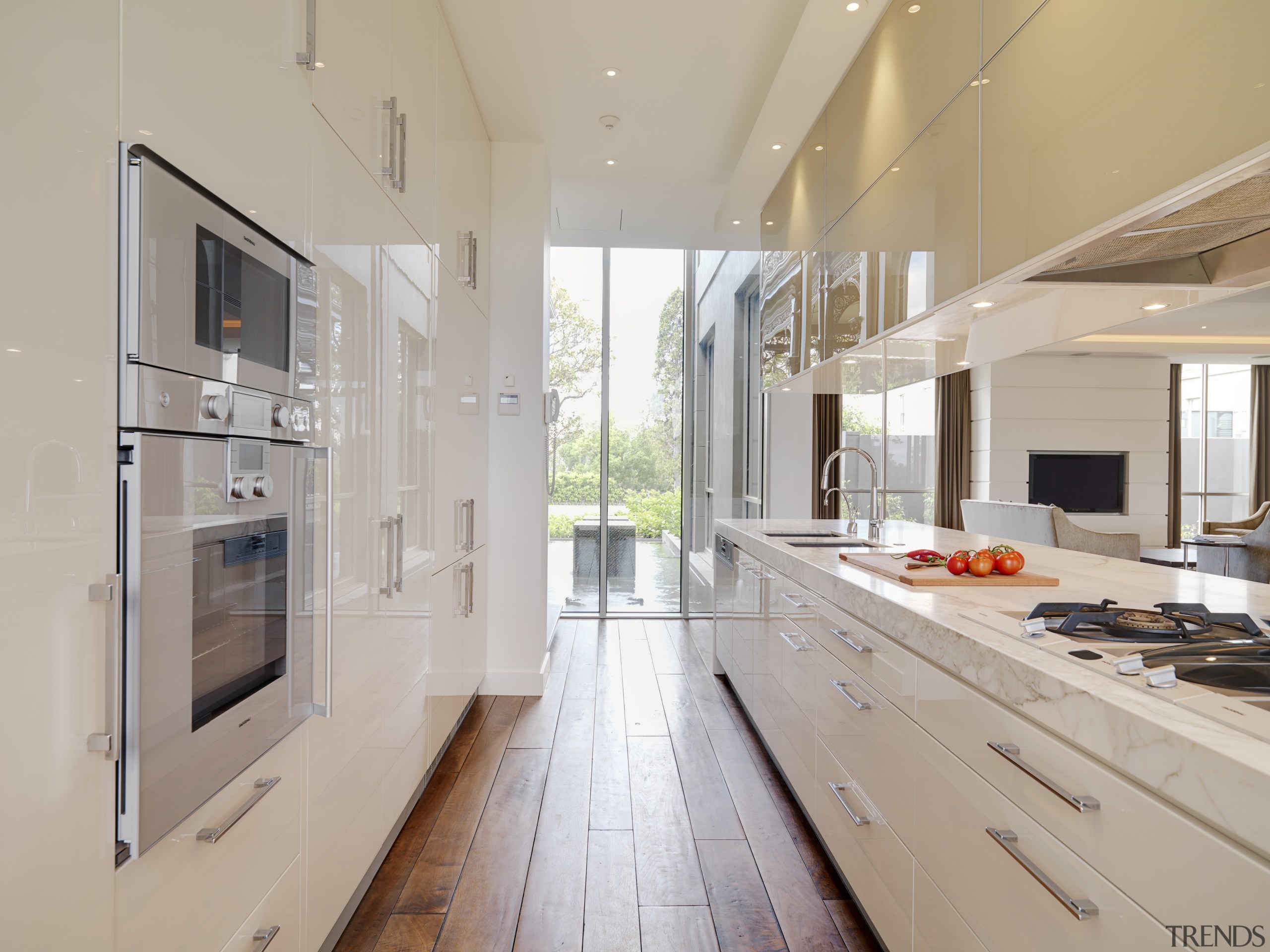 View of large marble island with cooktop, sinks cabinetry, countertop, cuisine classique, floor, interior design, kitchen, real estate, gray