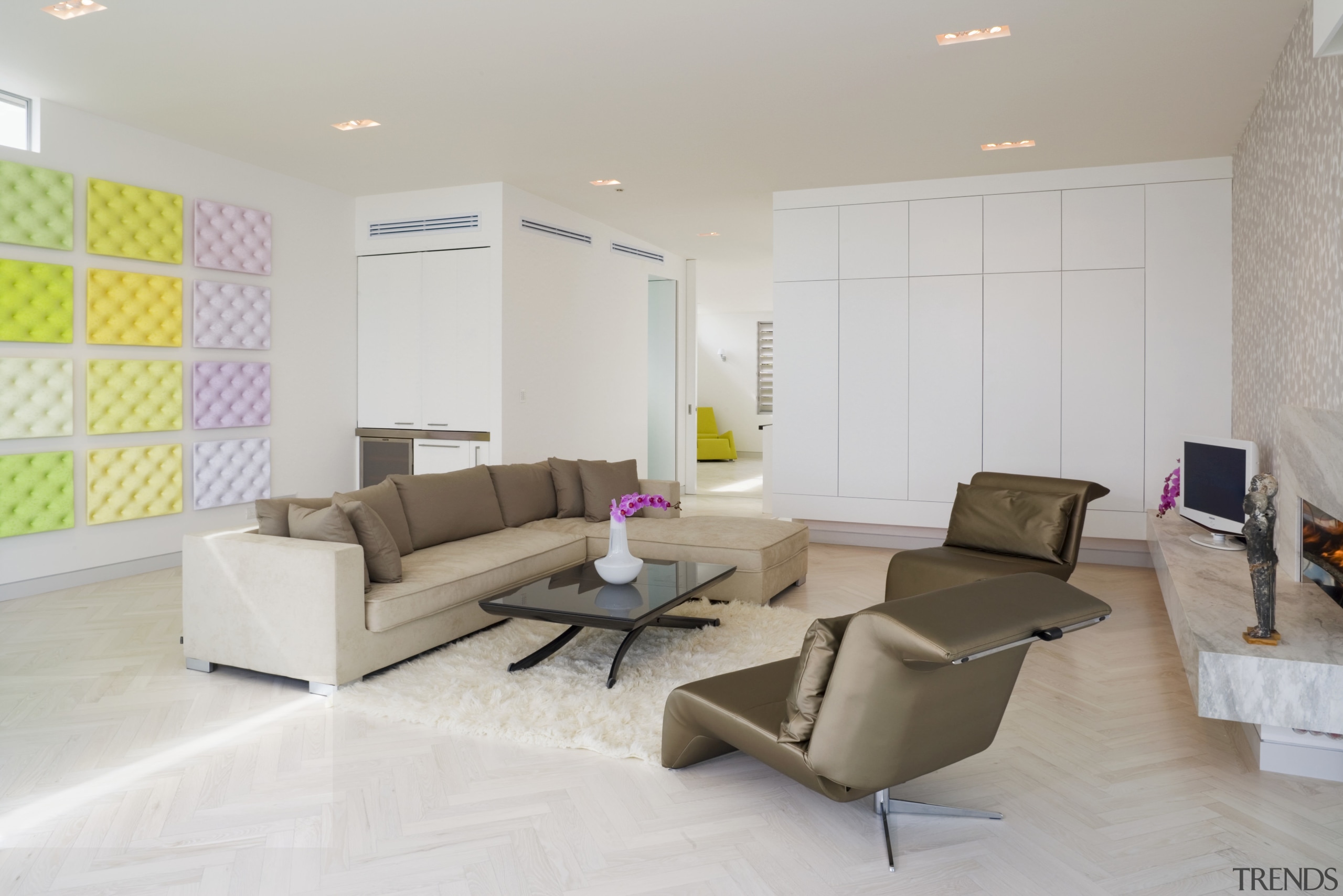 A shag-pile rug and suede modular sofa visually ceiling, floor, flooring, interior design, interior designer, living room, property, real estate, room, wall, gray