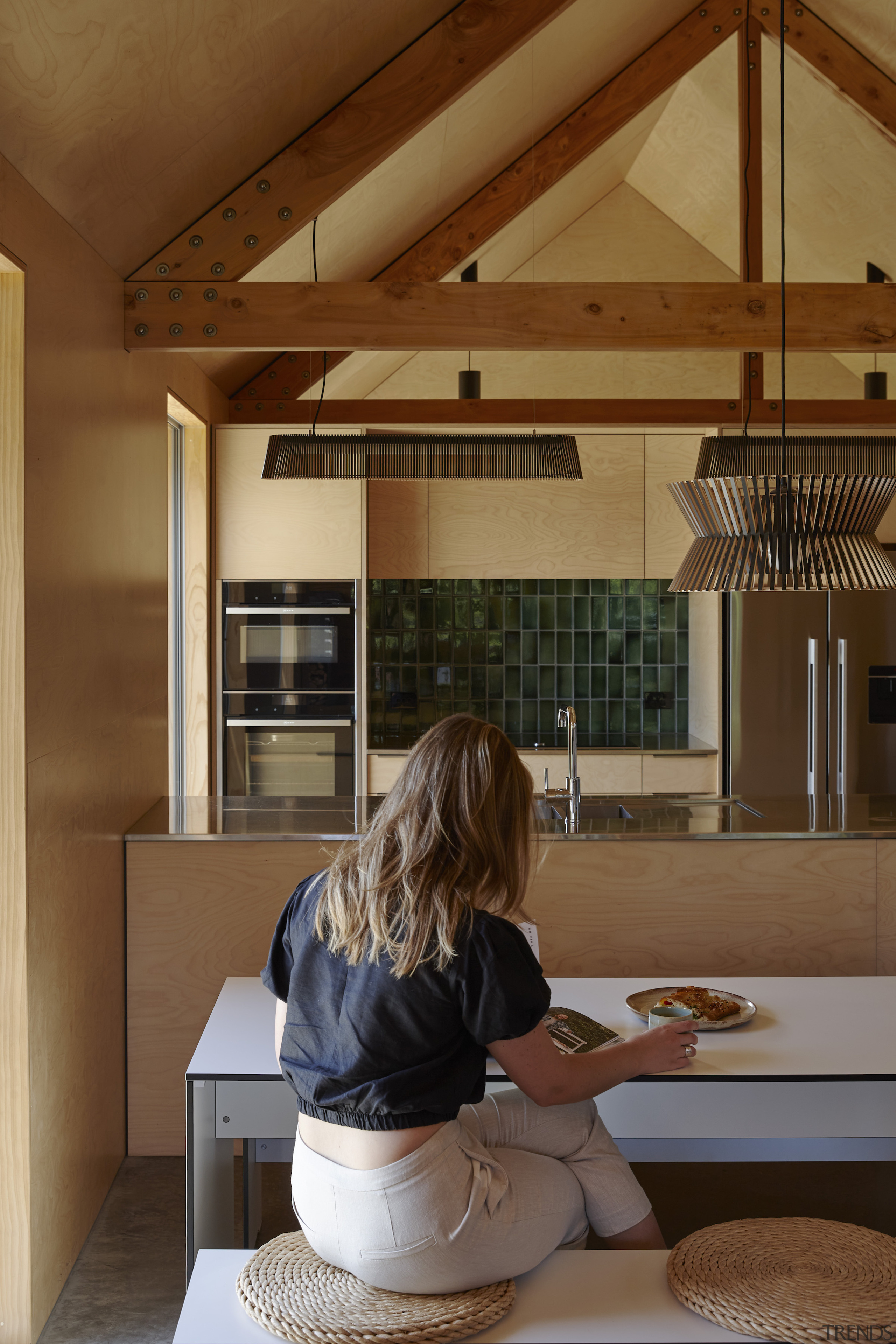 The exposed timber trusses over the kitchen space 