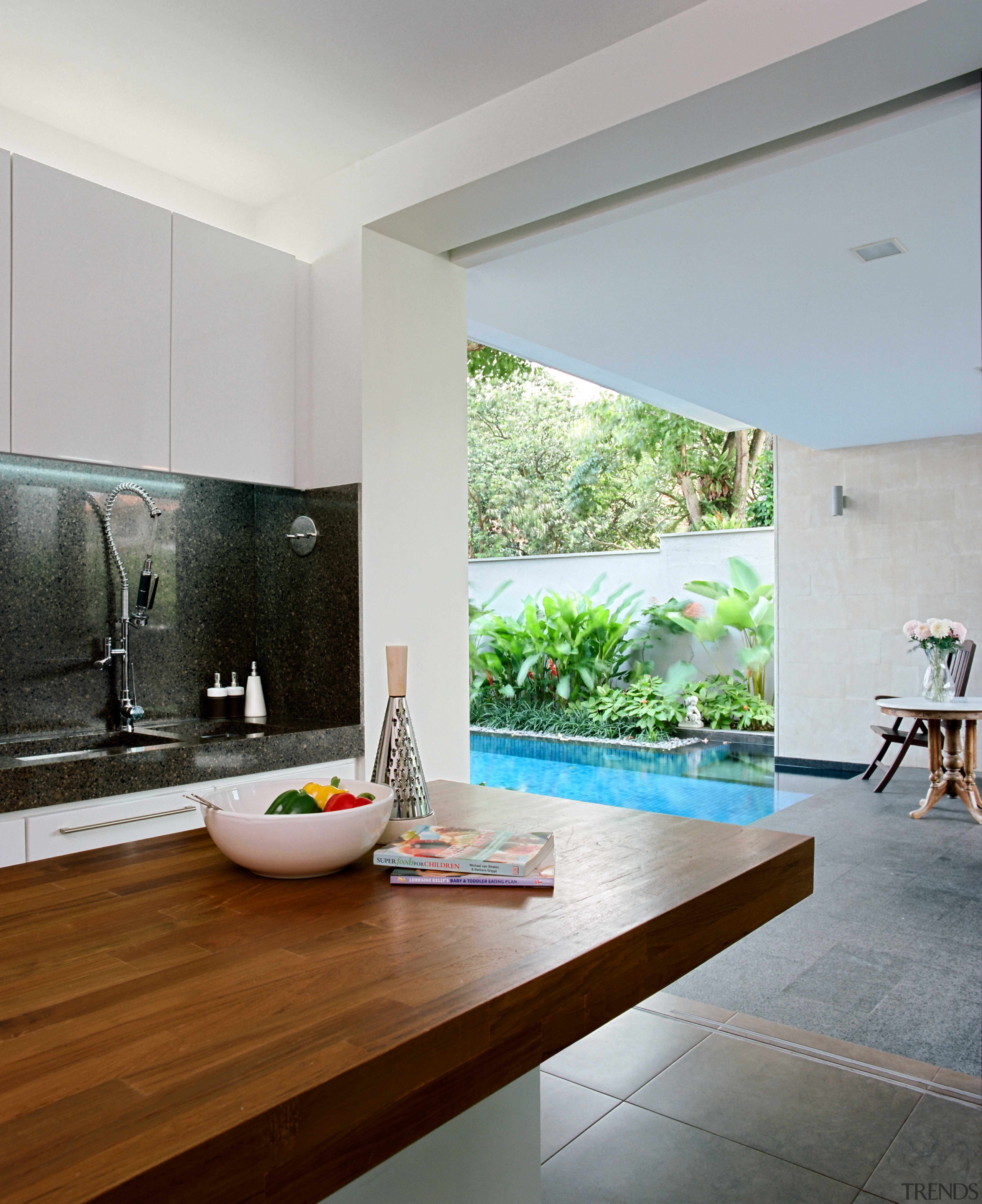 view of kitchen area which features a kitchen architecture, ceiling, countertop, floor, flooring, home, house, interior design, living room, real estate, room, table, tile, wall, window, wood flooring, gray