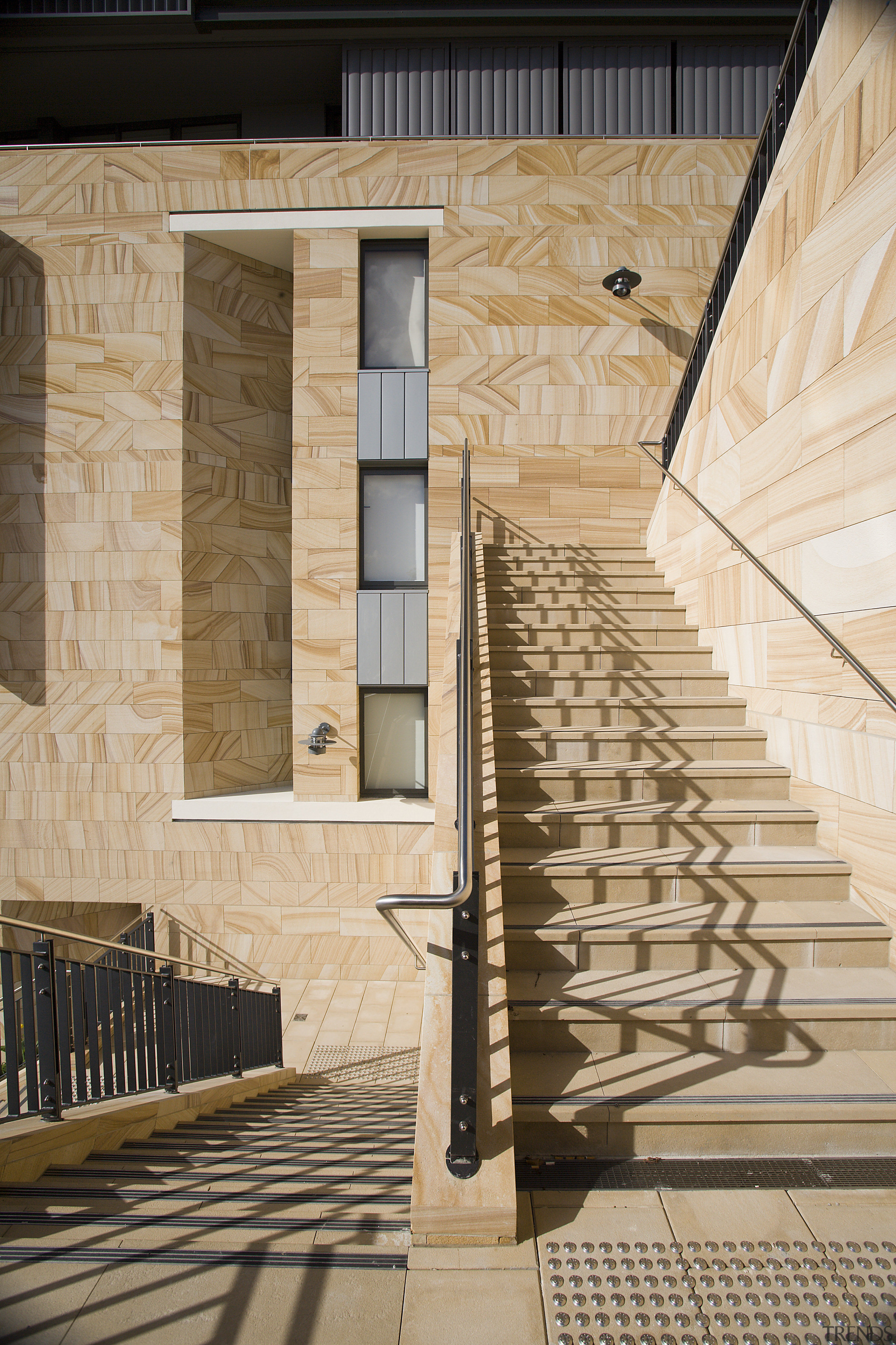 An exterior view of the apartments. - An architecture, baluster, building, daylighting, facade, handrail, stairs, structure, wall, window, wood, orange