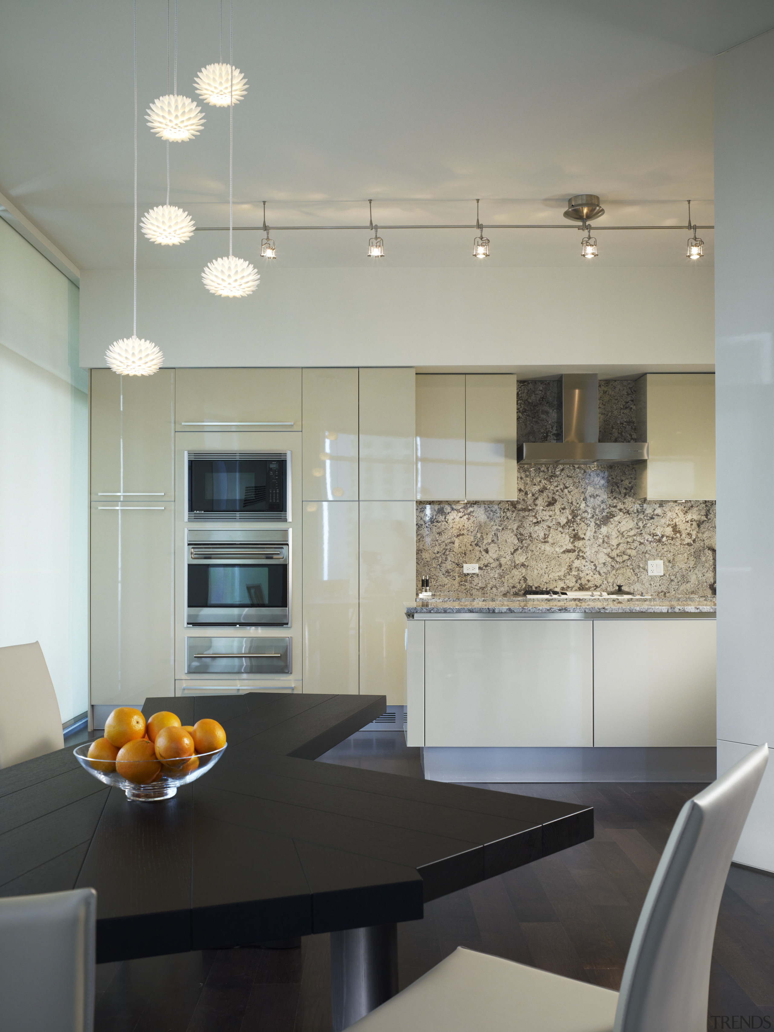 View of the kitchen featuring Pashmina Heartland granite cabinetry, ceiling, countertop, interior design, kitchen, light fixture, lighting, room, table, under cabinet lighting, gray