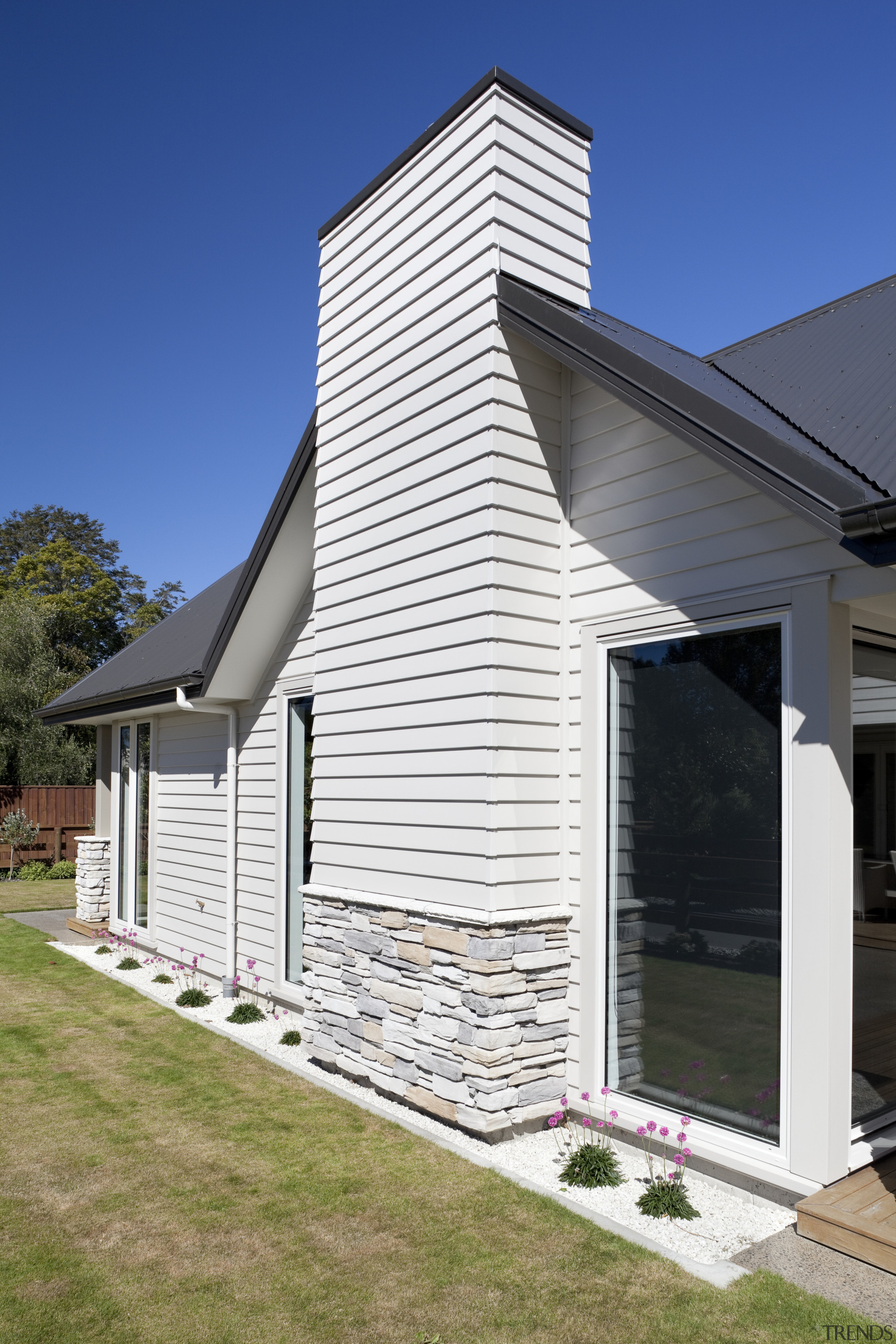 Exterior of house with white cladding and stone architecture, building, cottage, elevation, facade, home, house, real estate, residential area, siding, sky, window, white, blue