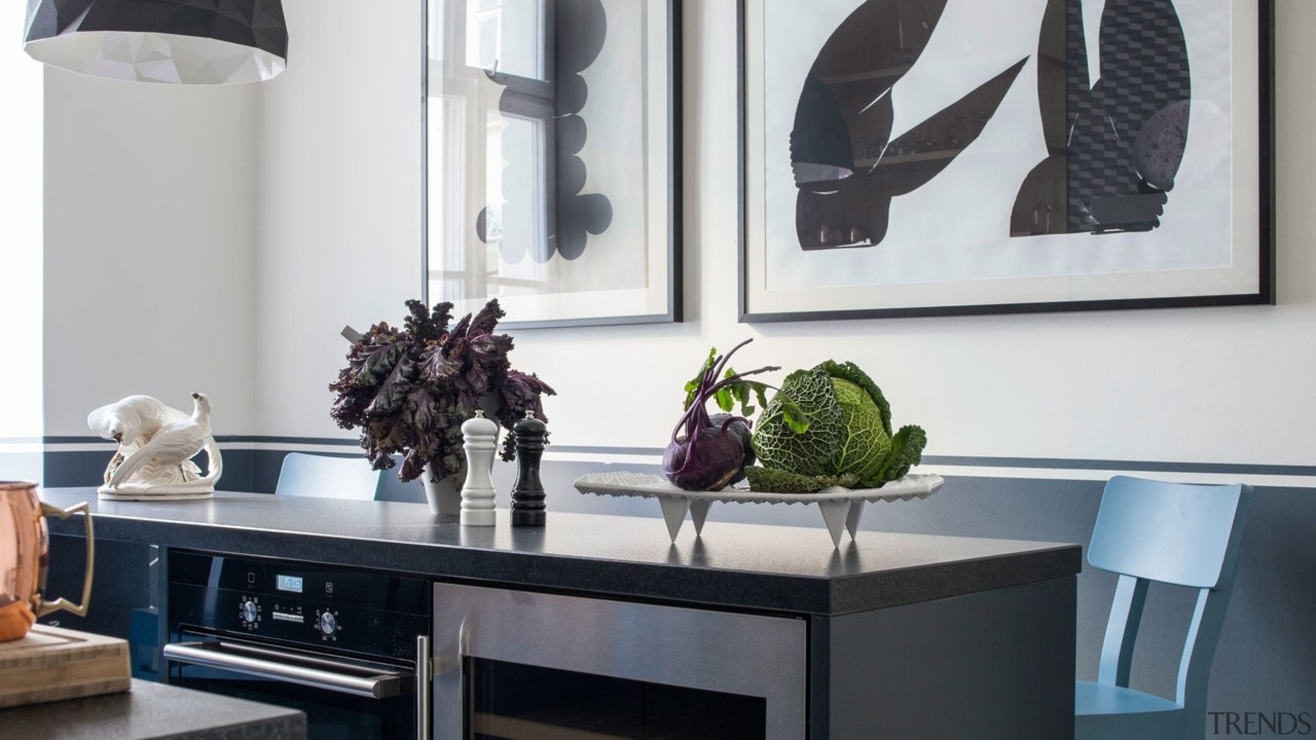 The colour blocking on this kitchen's walls building, ceiling, countertop, design, dining room, floor, flooring, furniture, home, house, houseplant, interior design, kitchen, living room, plant, property, room, shelf, shelving, table, tile, wall, white, black