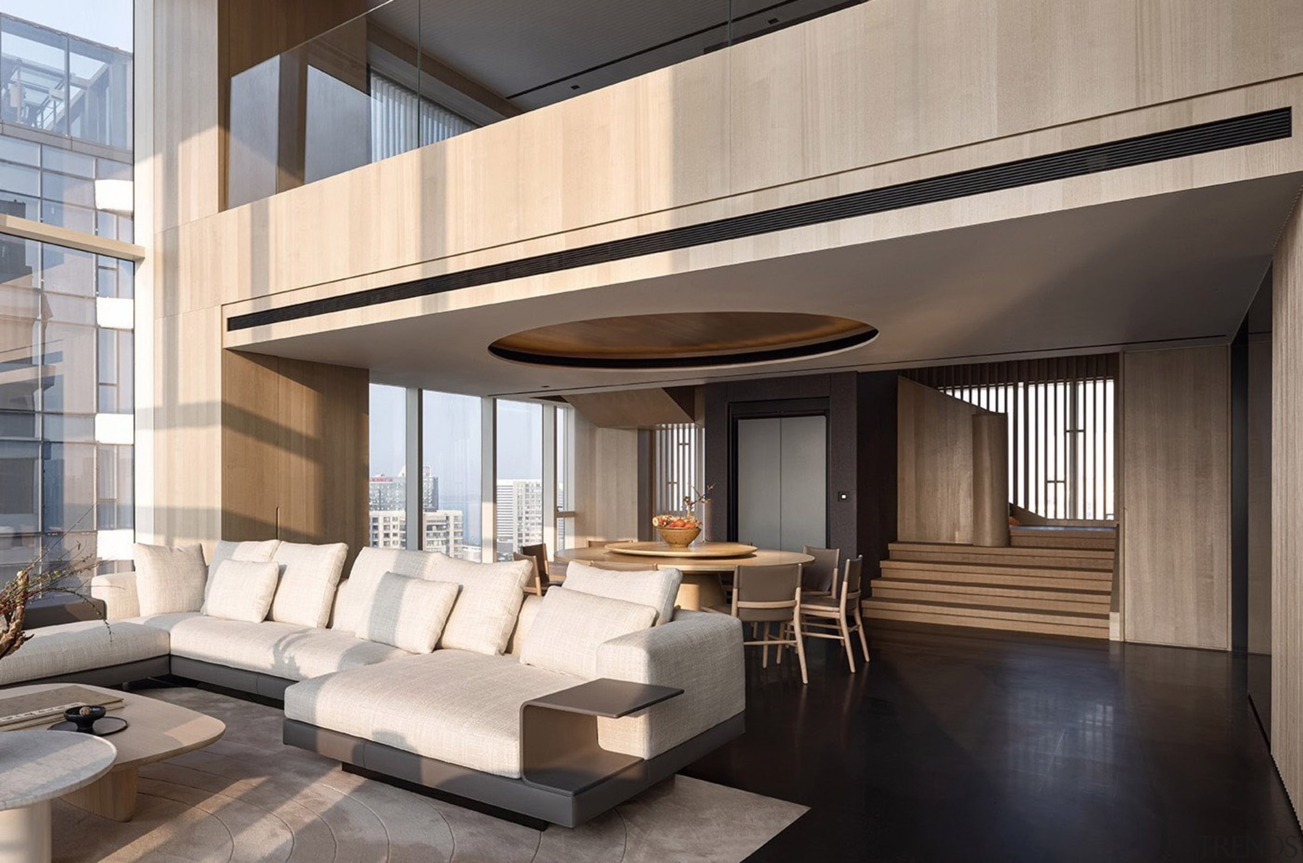 Featuring a double-deck ceiling, the spacious living room 