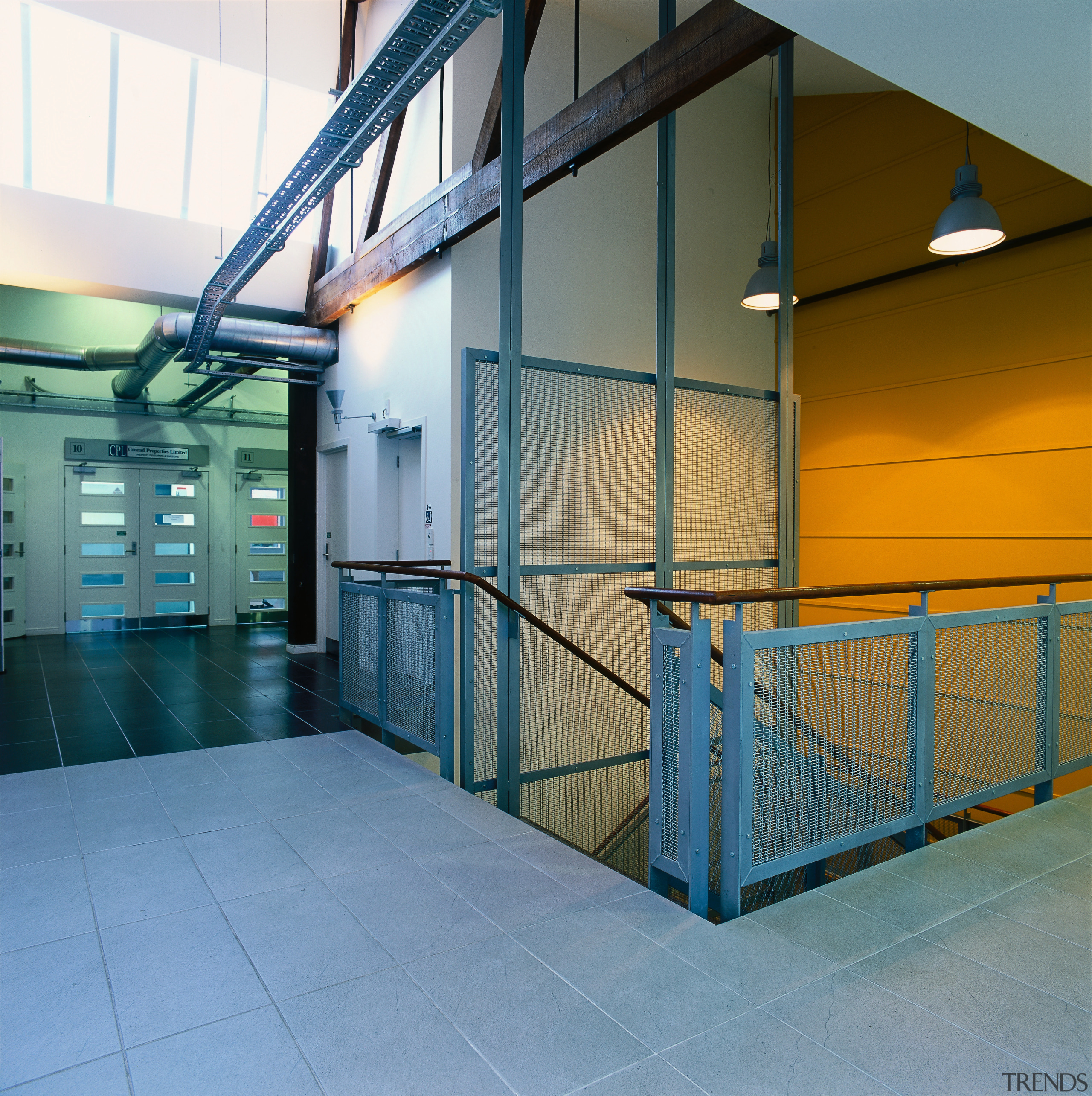 A bright mustard coloured wall and steel mesh architecture, daylighting, glass, leisure centre, real estate, structure, teal