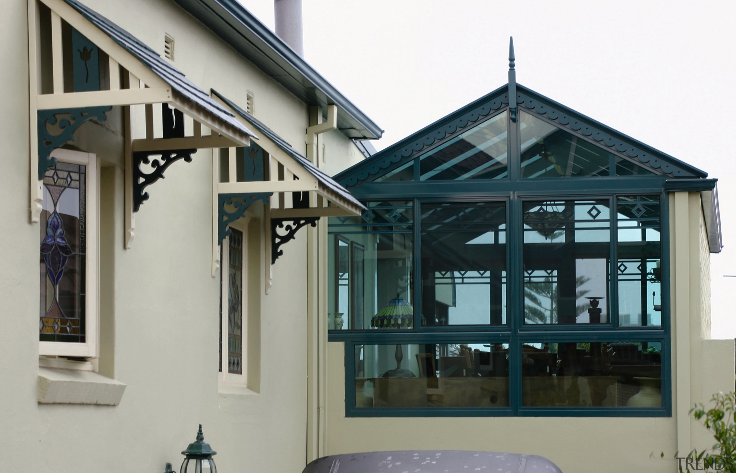 A view of a conservatory from the outside, facade, roof, window, gray, black