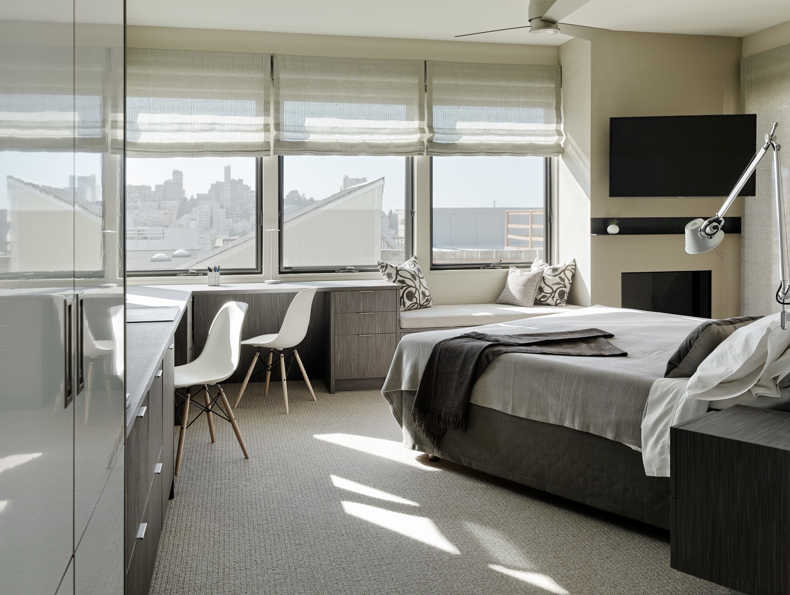 Built-in furniture in this master suite includes an bedroom, floor, flooring, furniture, interior design, room, window, window covering, gray