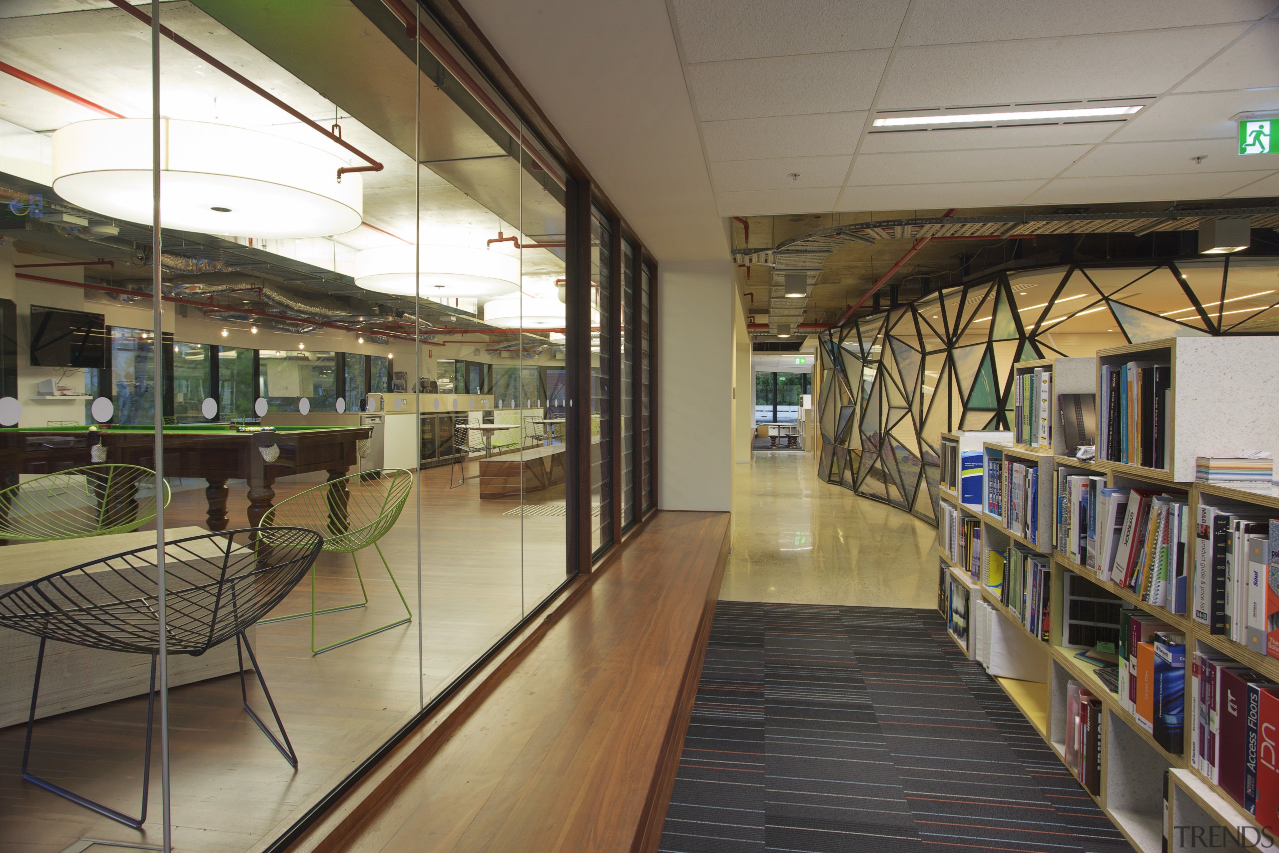 Interior with bookcases and grey carpeting. - Interior institution, library, brown
