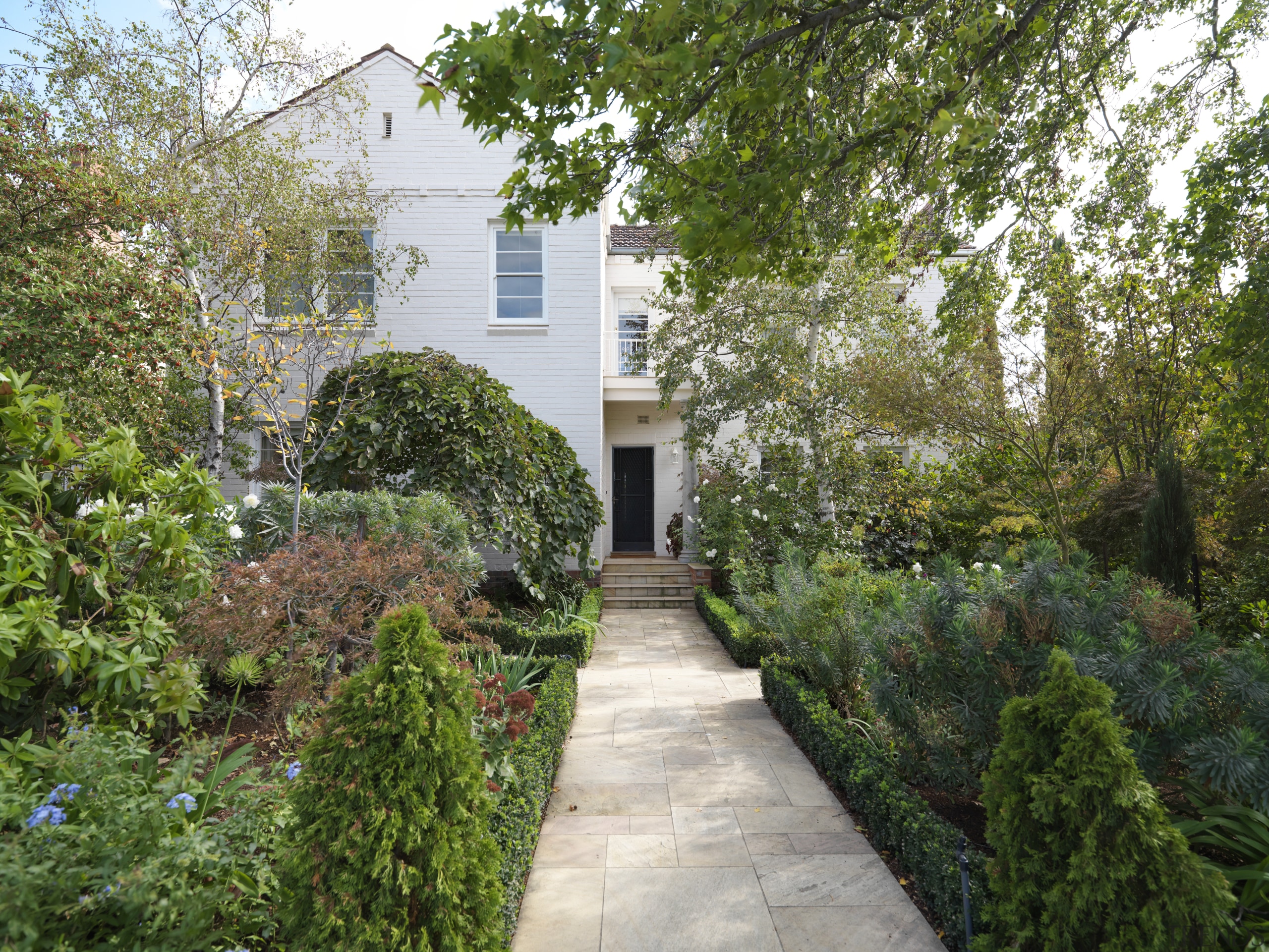 View of a landscaped garden which features a backyard, cottage, courtyard, estate, garden, home, house, landscaping, leaf, plant, property, real estate, residential area, shrub, tree, walkway, yard, brown, green