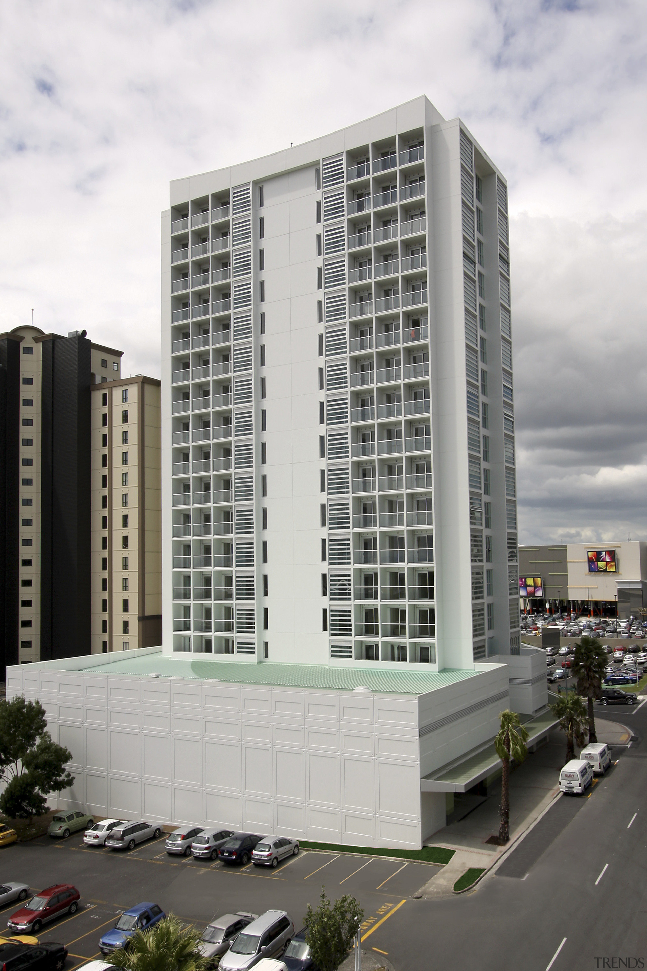 Exterior view of the entrance way of the apartment, architecture, building, commercial building, condominium, corporate headquarters, facade, headquarters, metropolis, metropolitan area, mixed use, real estate, residential area, tower block, white, gray