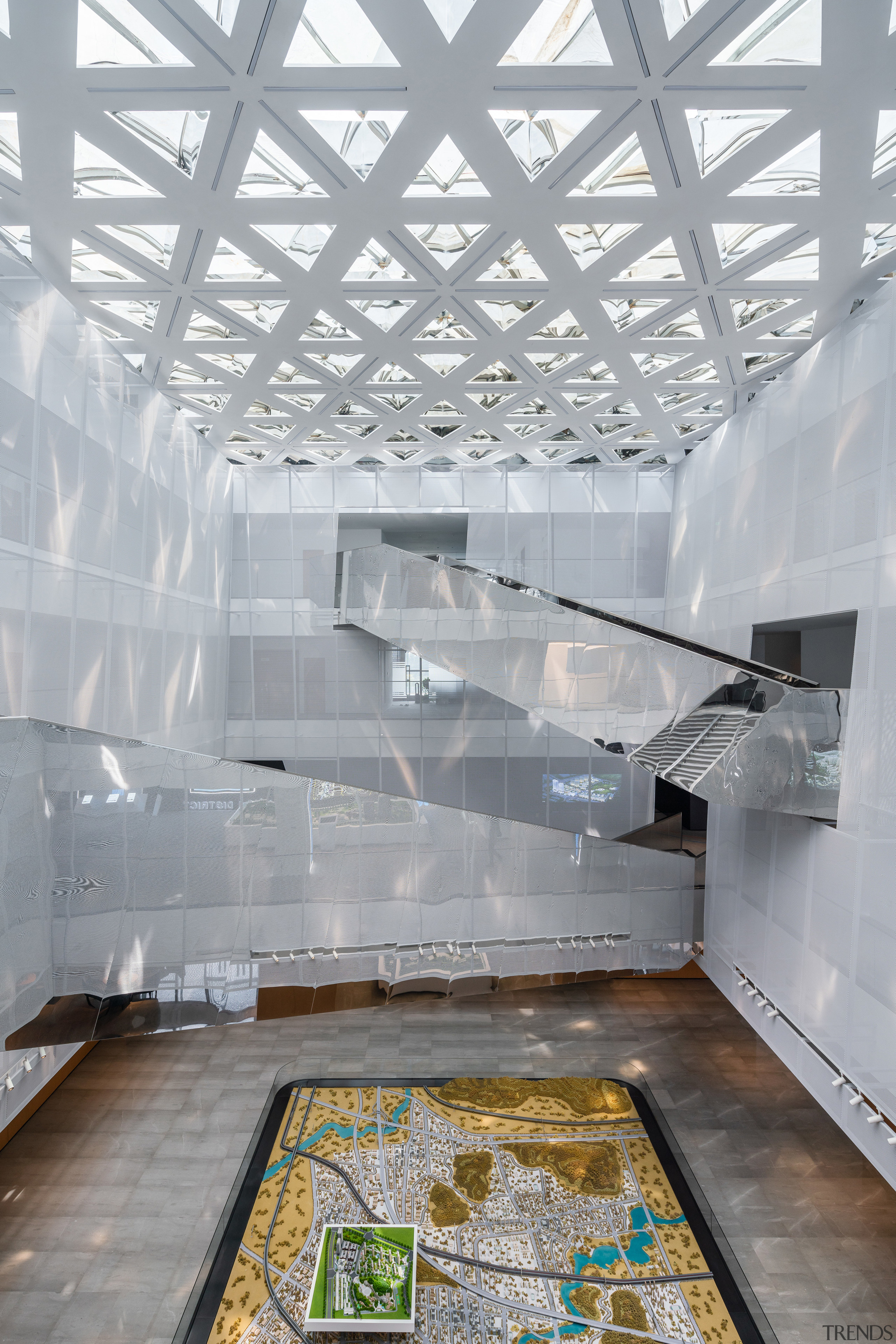 The tall atrium and the perforated plate material 