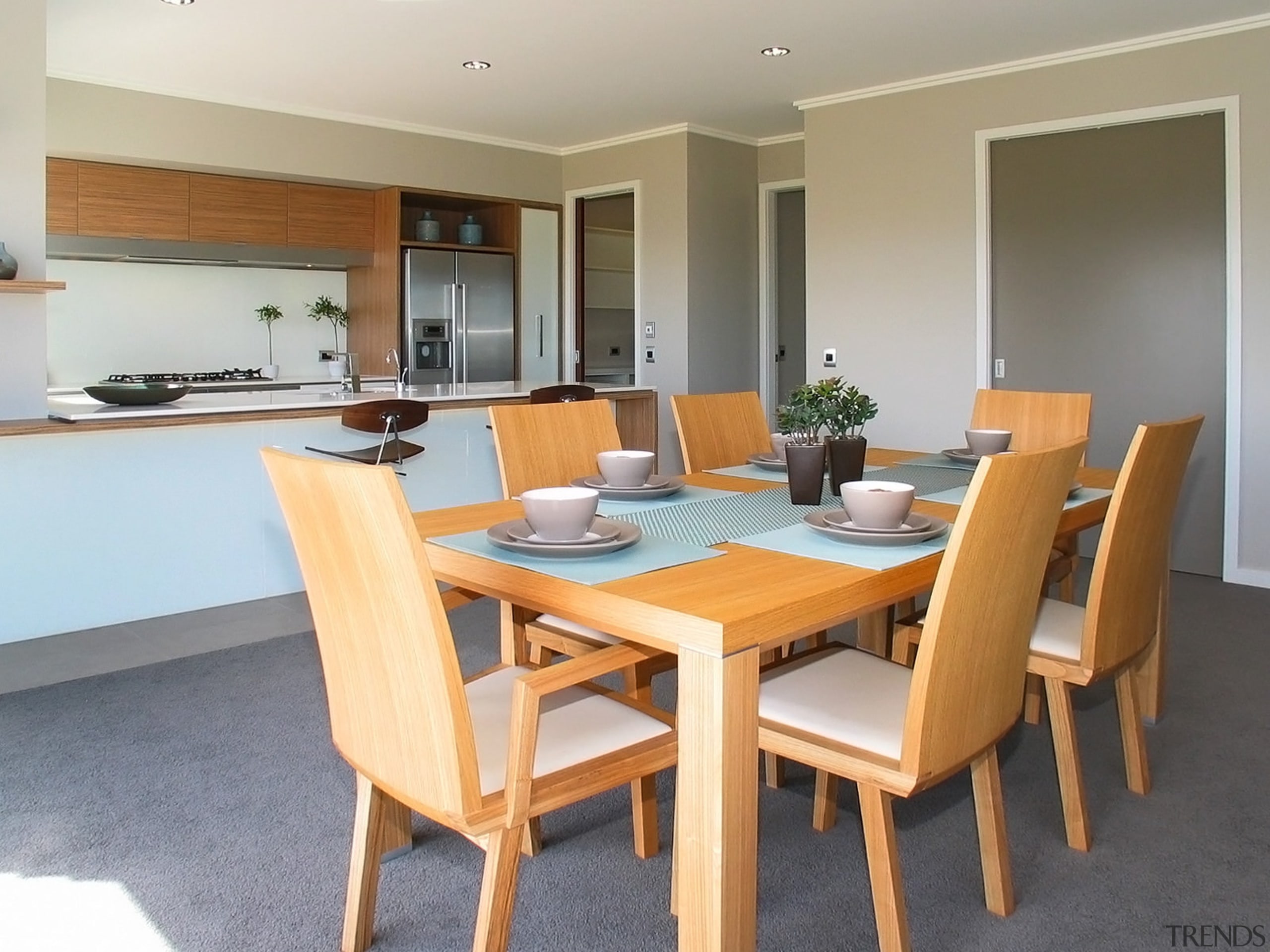View of kitchen and dining area which features chair, dining room, floor, flooring, furniture, interior design, property, real estate, room, table, gray