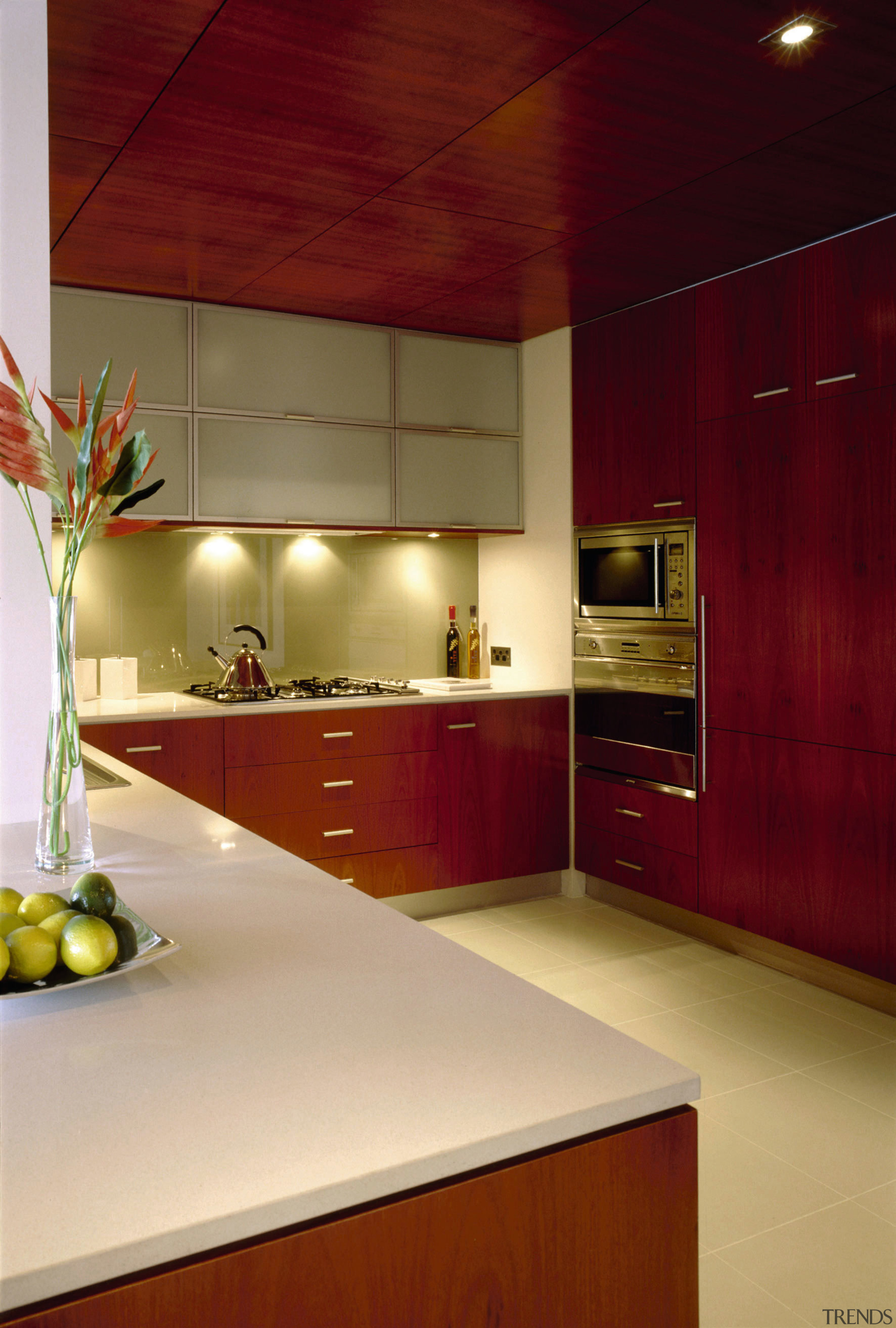 View of the kitchen's countertops - View of architecture, cabinetry, ceiling, countertop, interior design, kitchen, room, under cabinet lighting, red, orange
