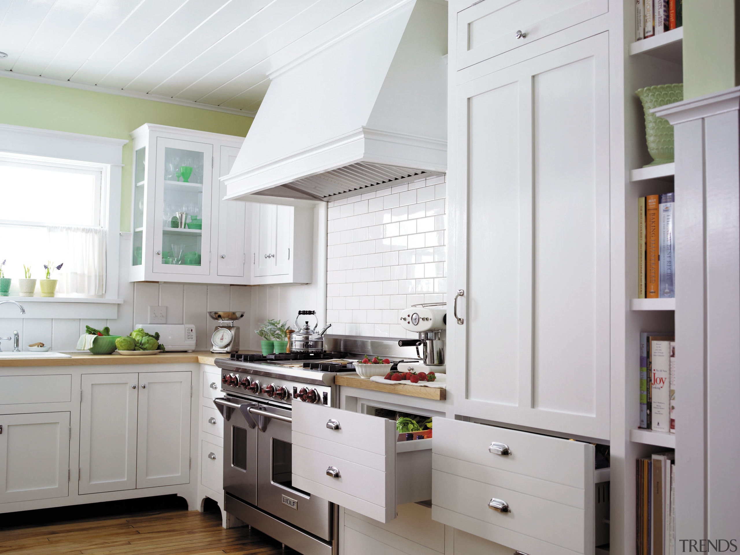 view of this kitchen featuring stainless steel wolf cabinetry, countertop, cuisine classique, floor, home, home appliance, interior design, kitchen, refrigerator, room, gray, white