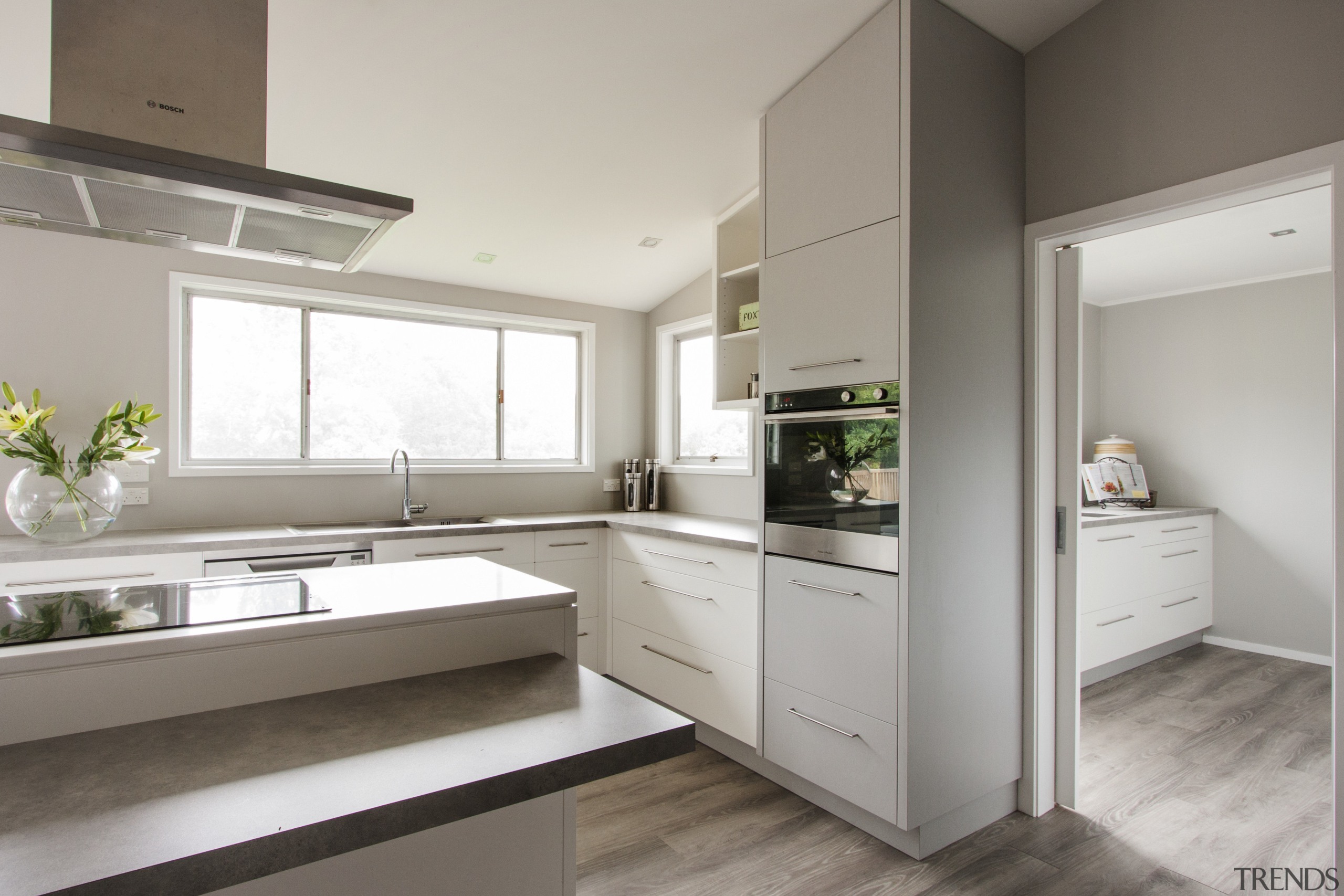 This large scullery in a kitchen by Callidus cabinetry, countertop, cuisine classique, interior design, kitchen, real estate, gray