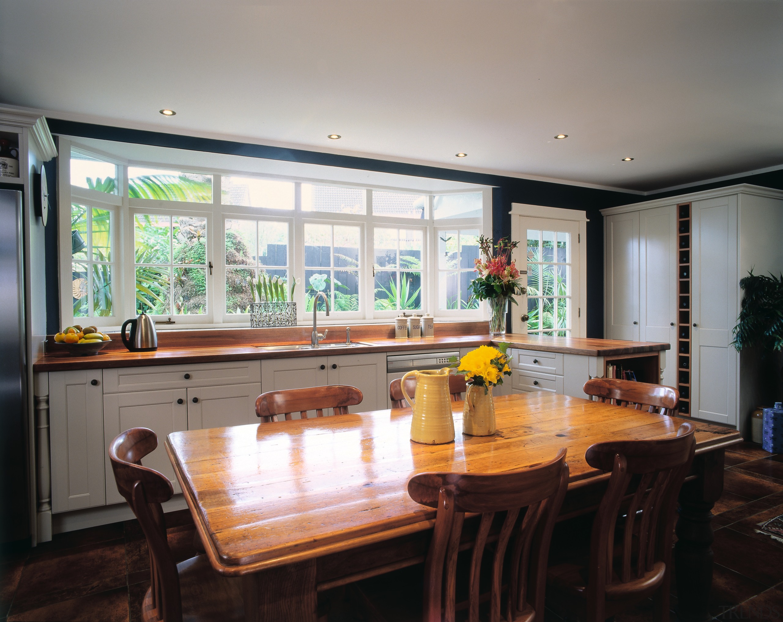 The view of a traditional styled kitchen - countertop, dining room, interior design, kitchen, property, real estate, room, table, window, gray, black