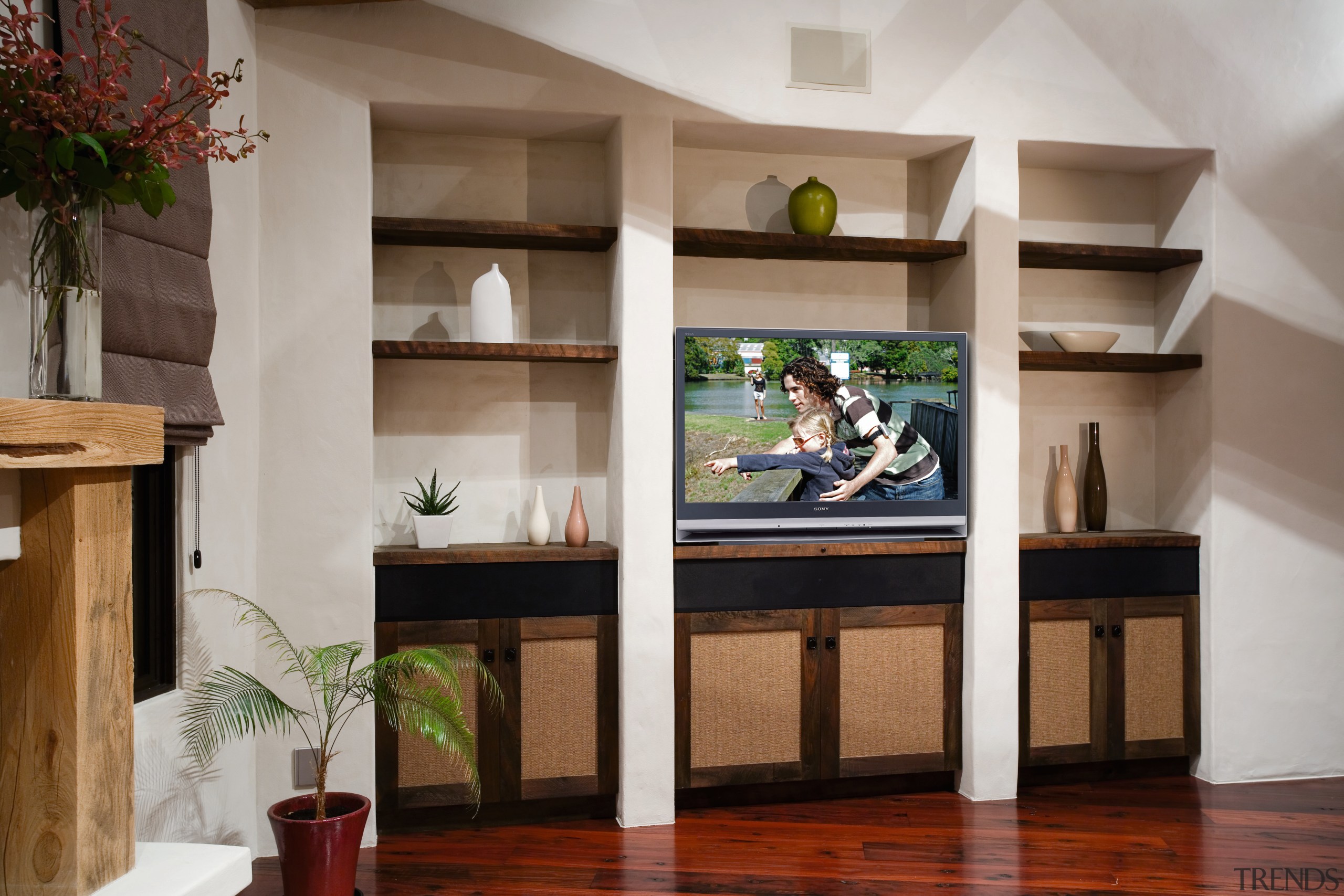 Room with shelving, cabinets and projection television. bookcase, furniture, interior design, living room, shelf, shelving, table, gray, brown
