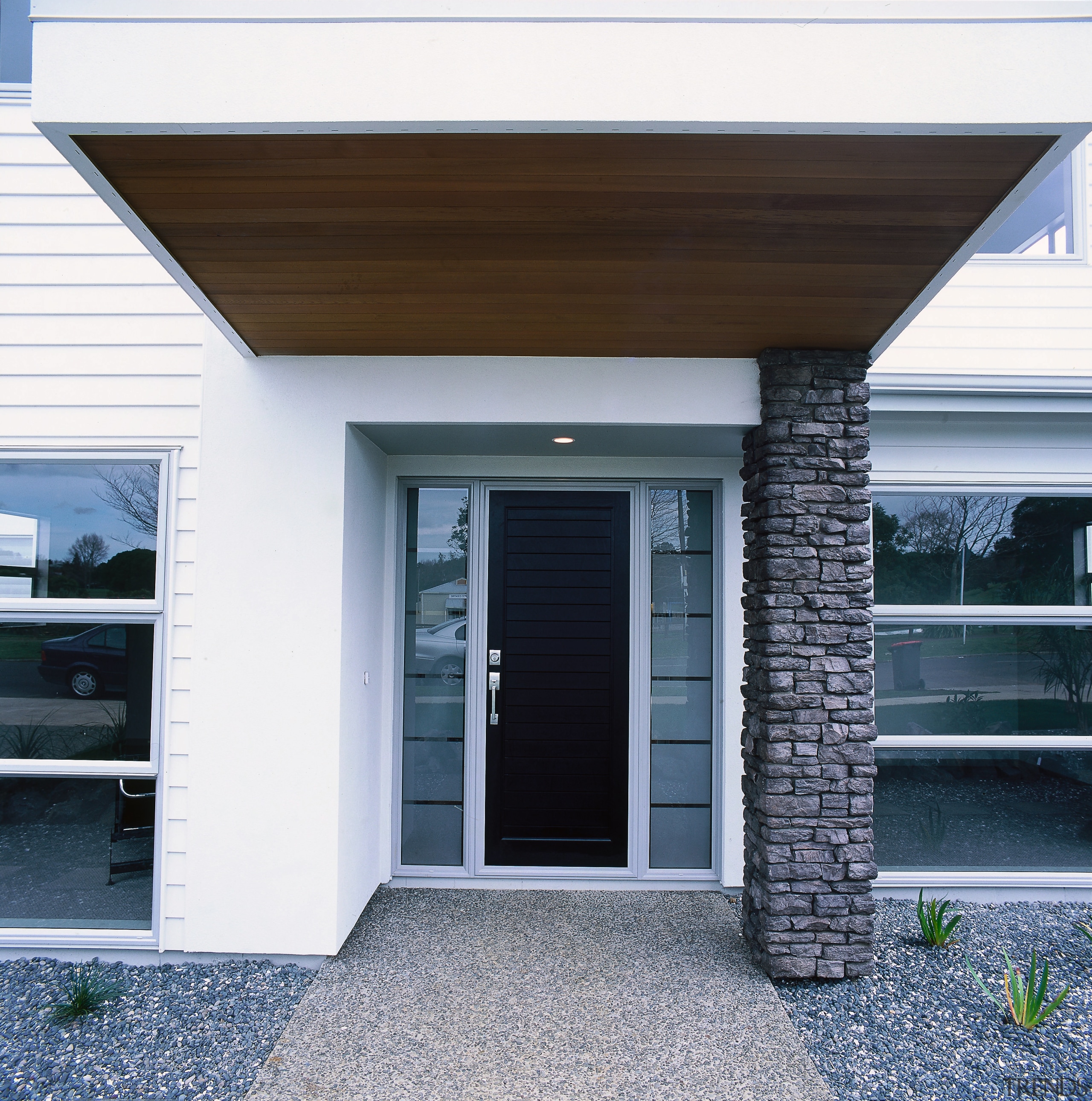 view of this contemporary jalcon show home featuring door, facade, home, house, real estate, siding, window, white