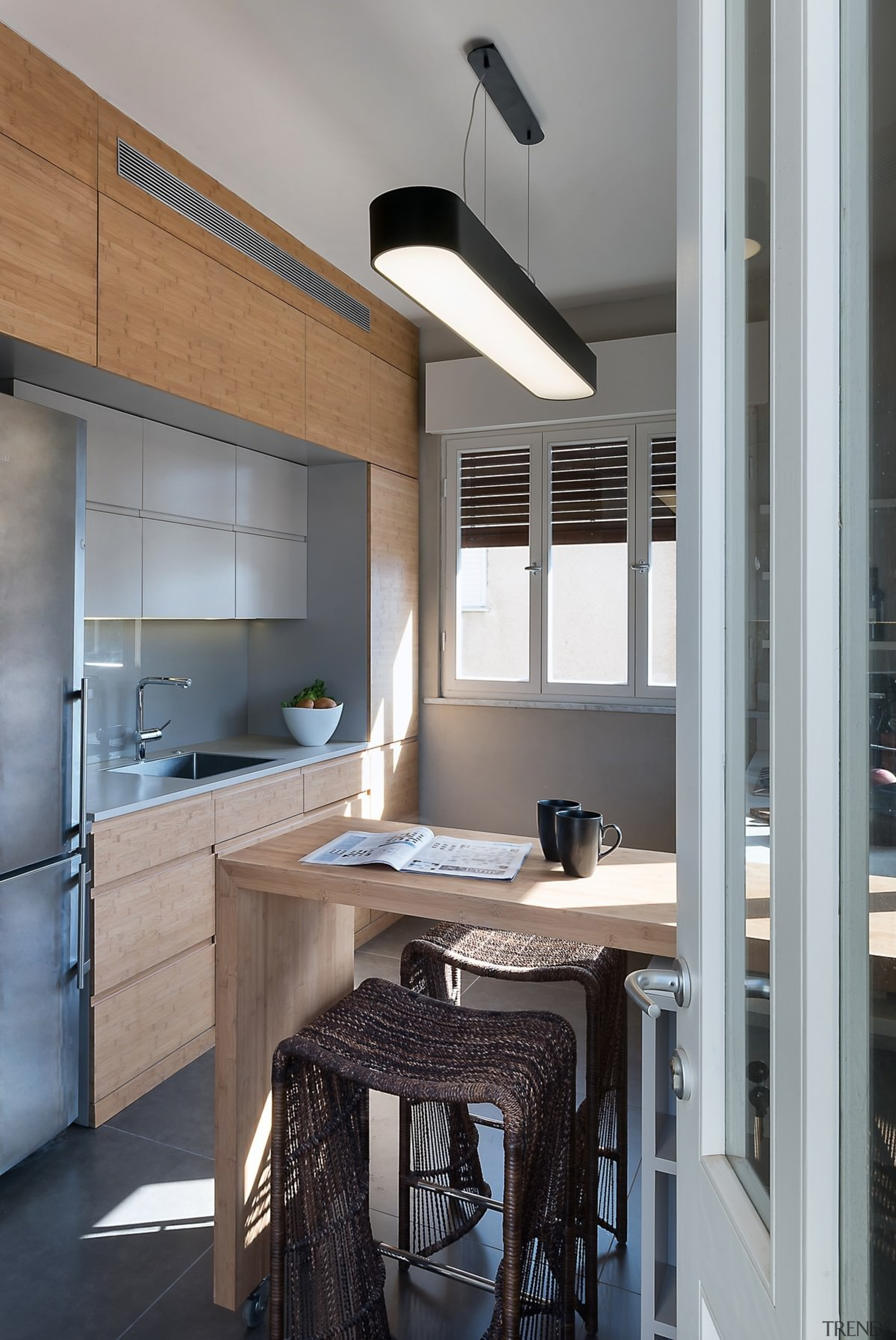 A large light is the centrepiece of the cabinetry, countertop, cuisine classique, interior design, kitchen, gray