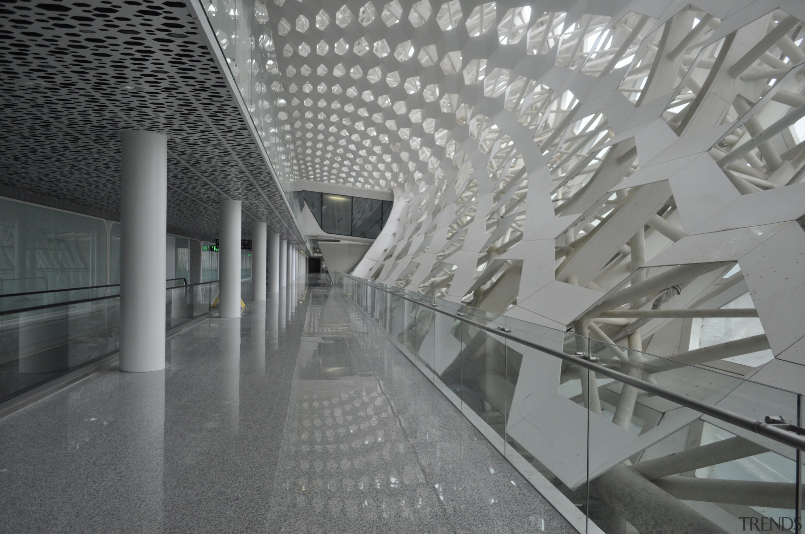 Looking much like a giant sculpture from both airport terminal, architecture, building, ceiling, daylighting, glass, infrastructure, lobby, metropolitan area, structure, tourist attraction, gray