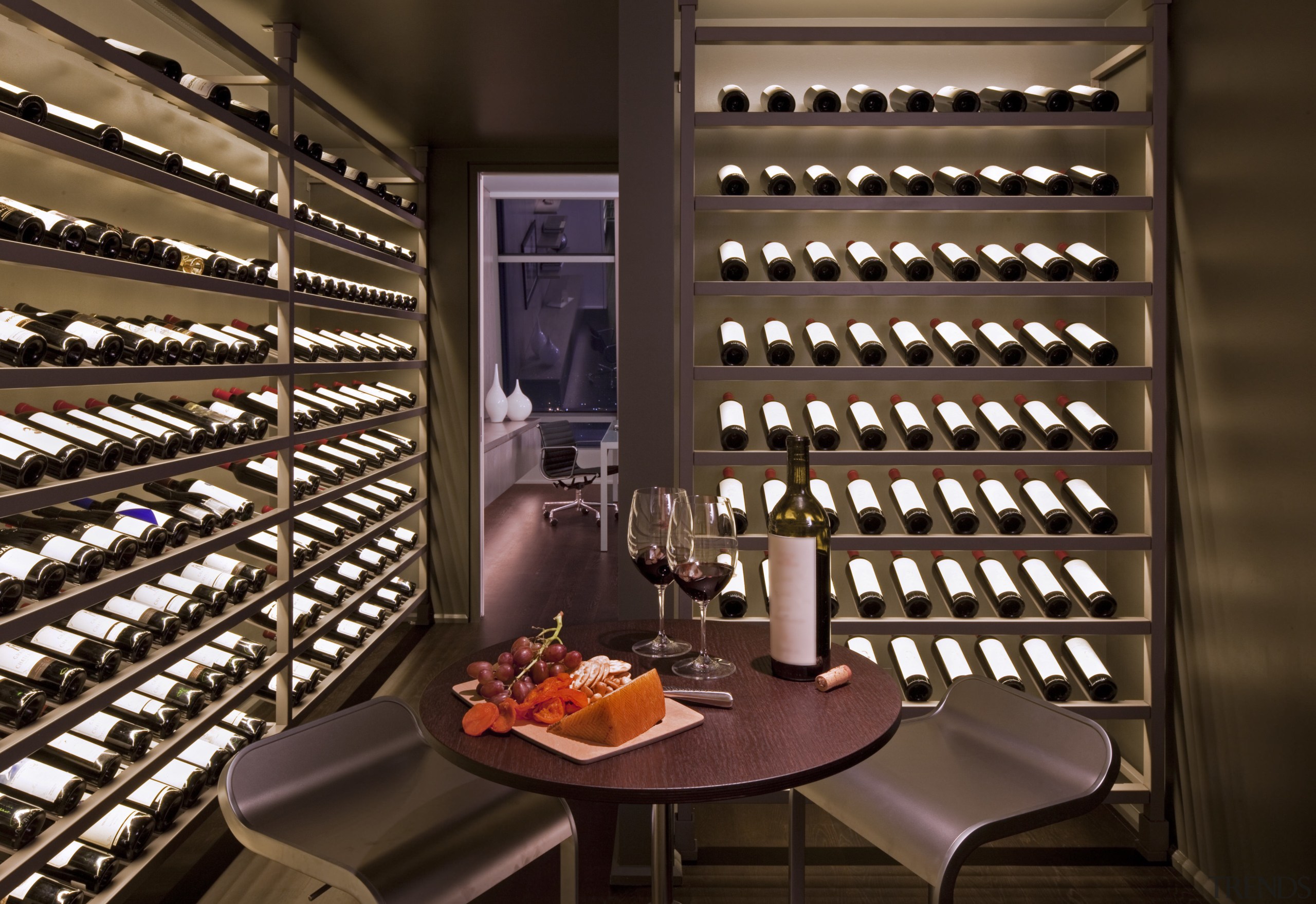 The climate-controlled wine cellar features custom, backlit wine interior design, wine cellar, winery, brown