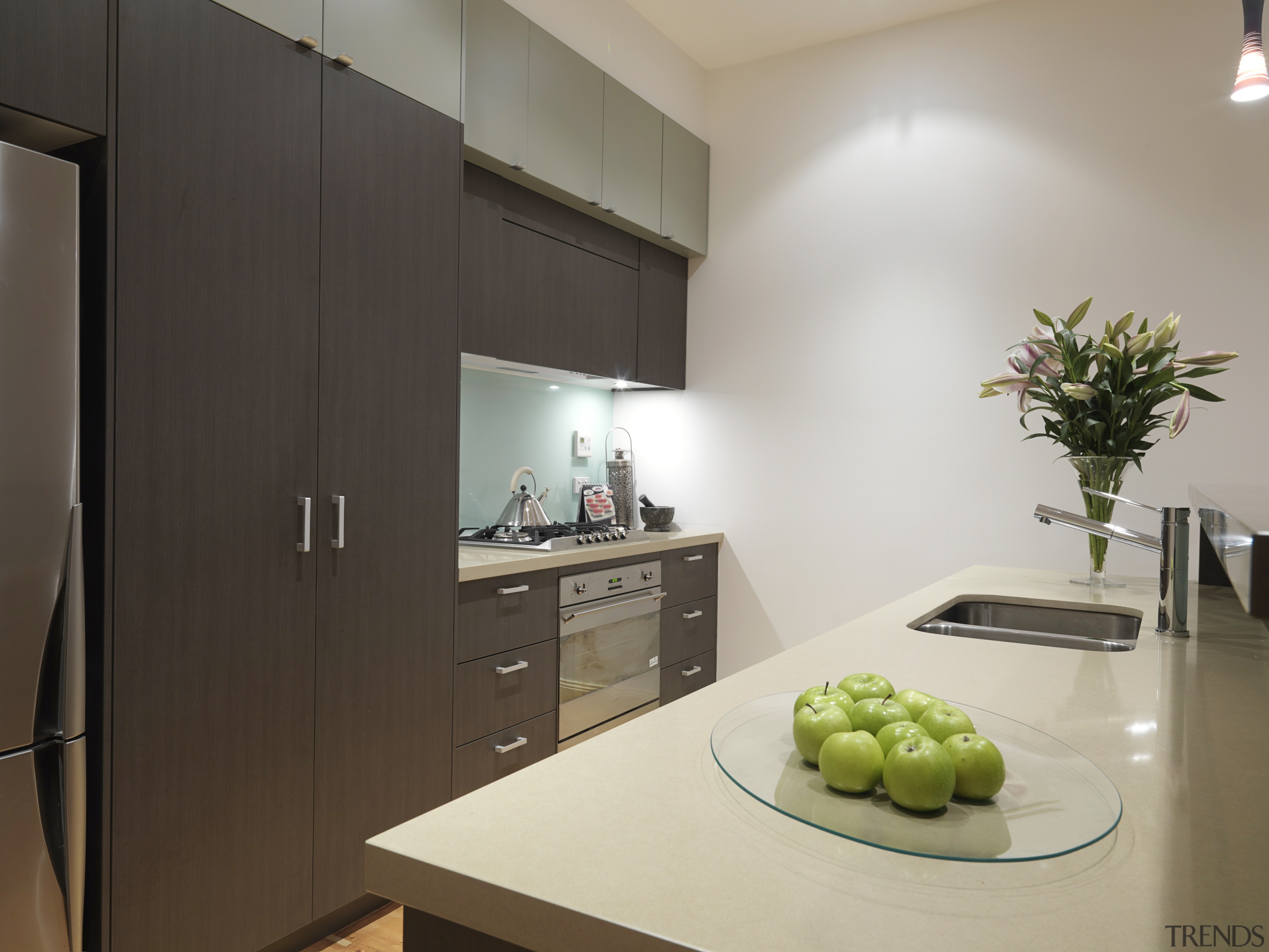 View of a kitchen featuring island, dark brown countertop, interior design, kitchen, real estate, room, gray, black