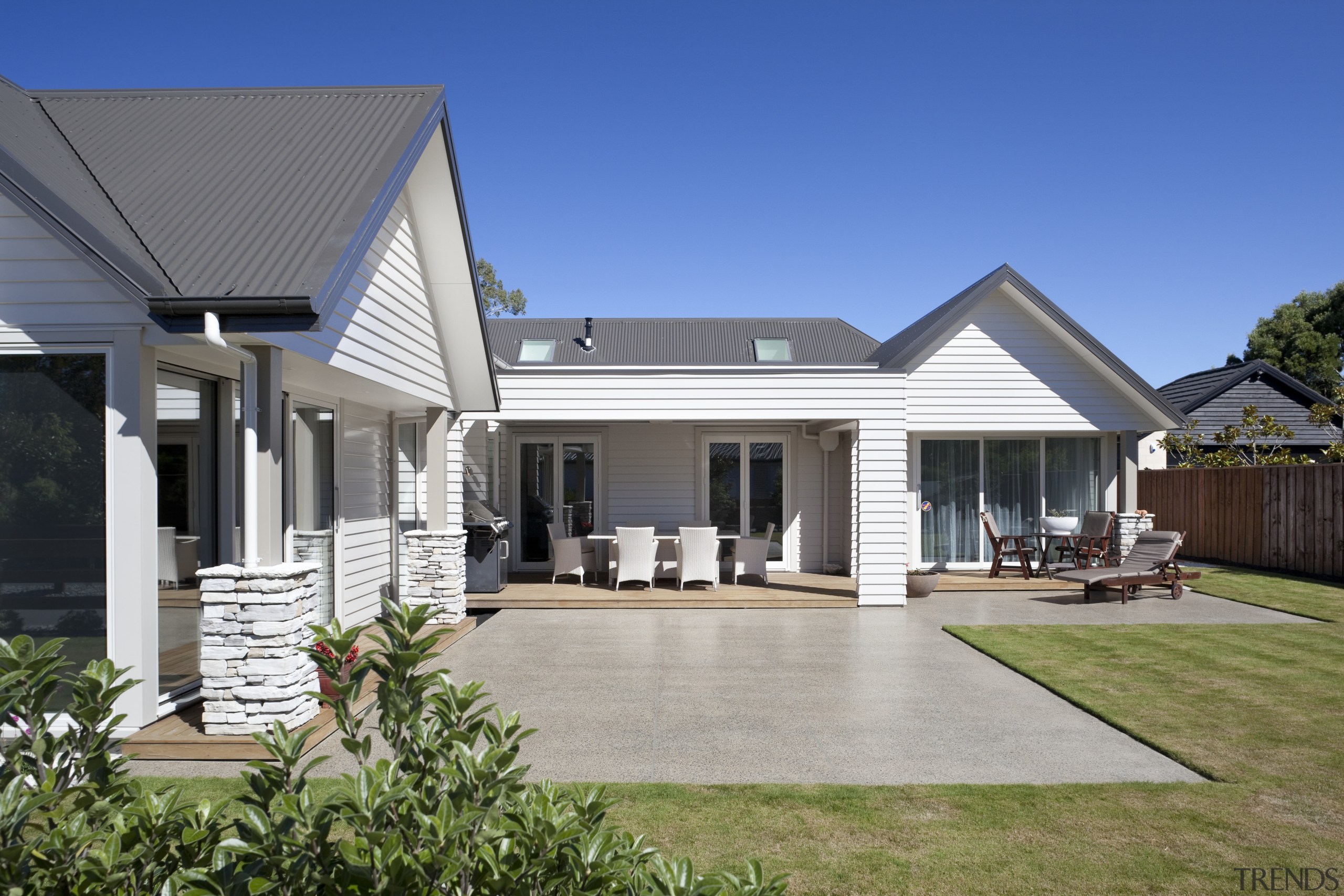 Exterior of house with white cladding, grey roof backyard, cottage, elevation, estate, facade, farmhouse, home, house, porch, property, real estate, residential area, roof, siding, villa, window, yard, gray, blue