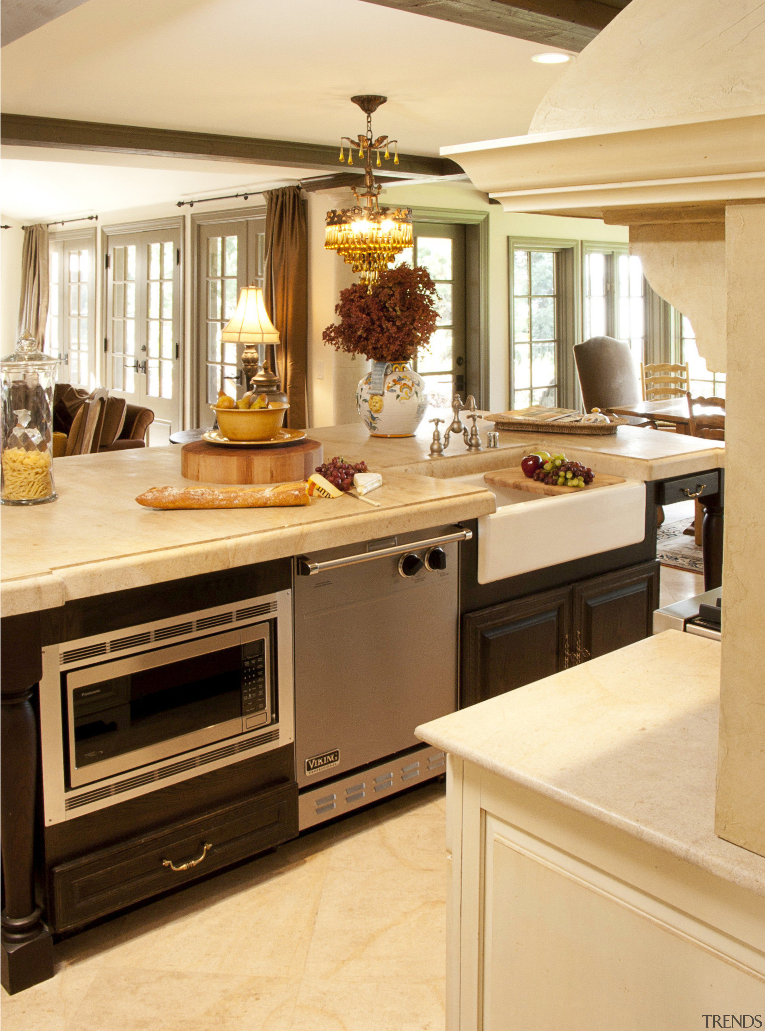 Dark wood beams in this Provencal-style kitchen relieve cabinetry, countertop, cuisine classique, floor, flooring, furniture, interior design, kitchen, room, orange, brown