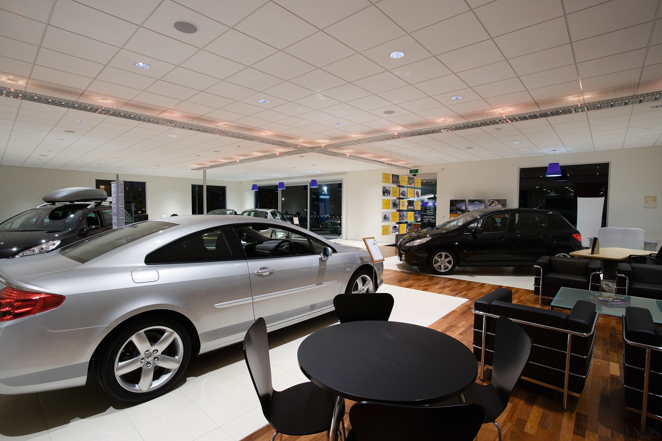 A view of the Puergot showroom. - A auto show, automotive design, building, car, car dealership, executive car, family car, luxury vehicle, motor vehicle, personal luxury car, technology, vehicle, gray, black