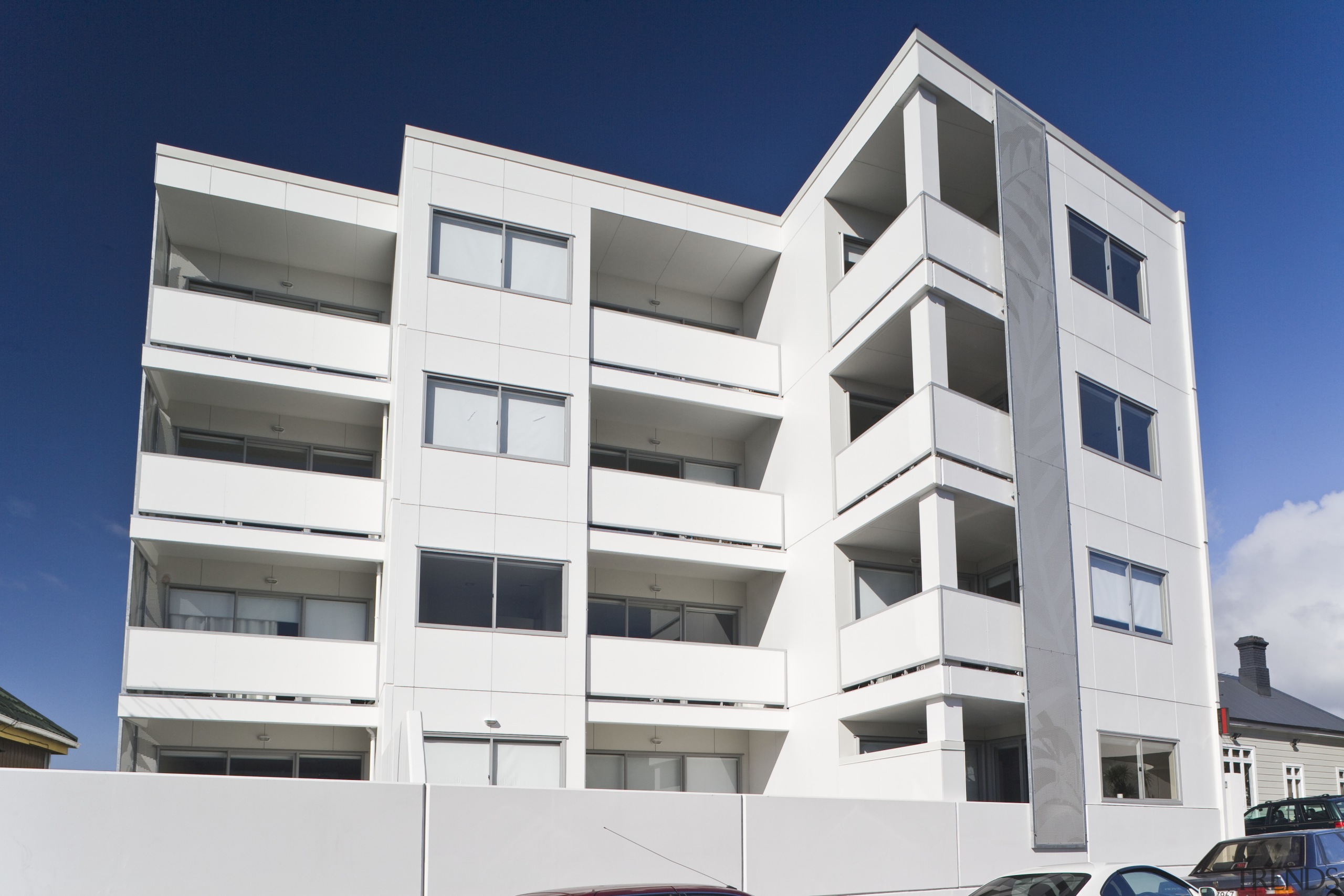 Exterior view of the Ivory apartments which features apartment, architecture, building, commercial building, condominium, corporate headquarters, elevation, facade, home, house, mixed use, property, real estate, residential area, white, blue