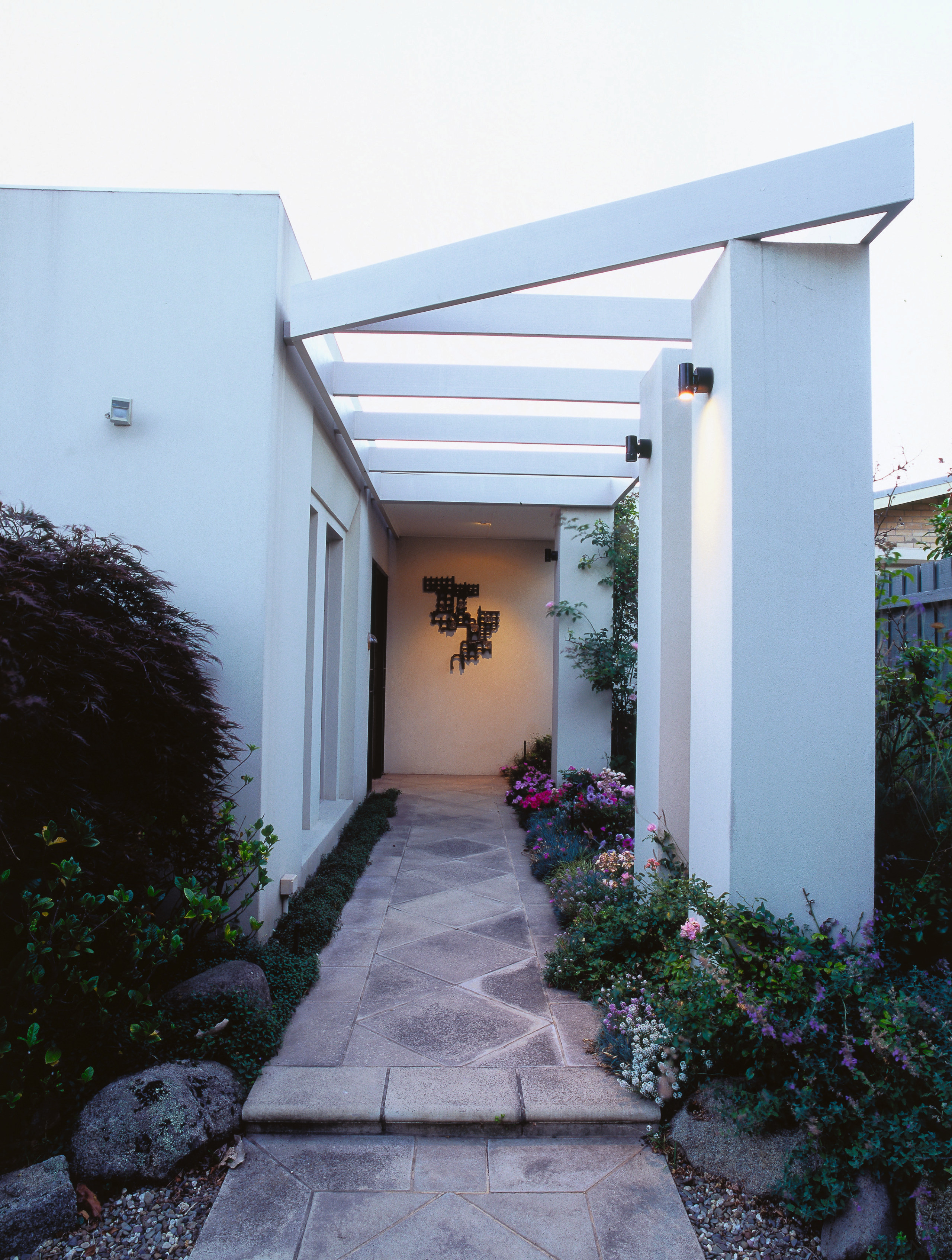 View of the entrance way to the home, architecture, backyard, courtyard, estate, facade, home, house, outdoor structure, property, real estate, residential area, walkway, white