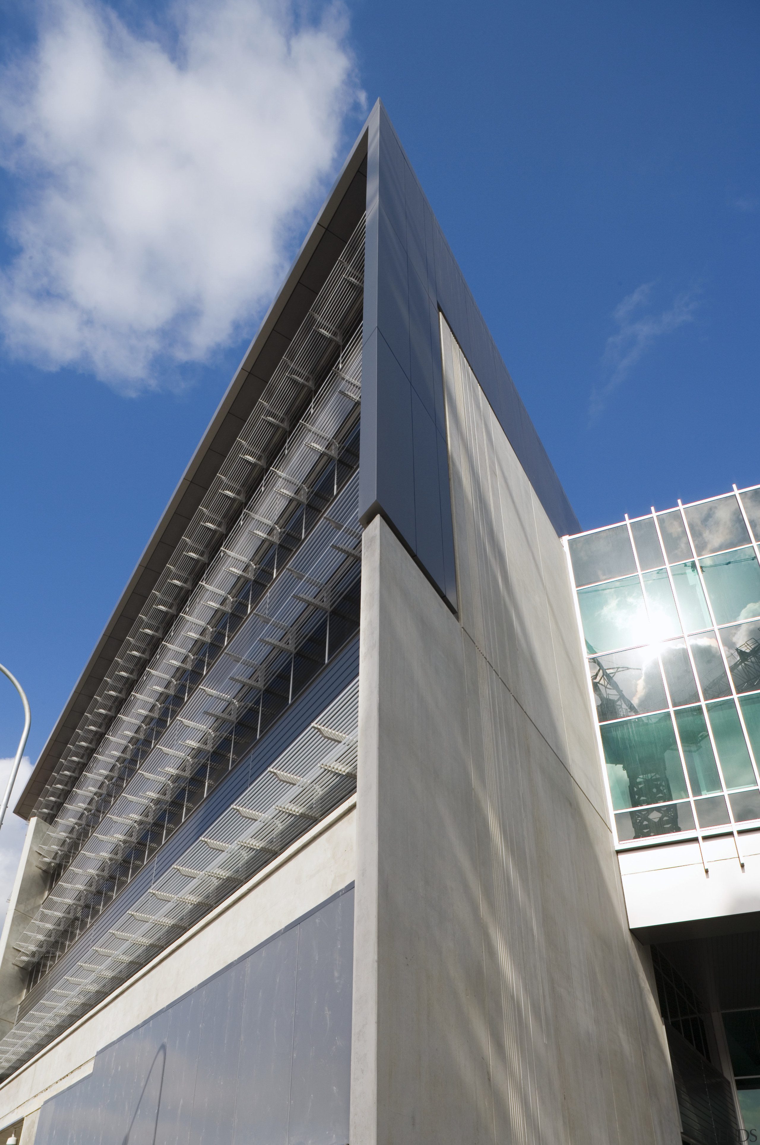 An exterior view of the greensquare building. DKL architecture, building, commercial building, condominium, corporate headquarters, daylighting, daytime, facade, headquarters, landmark, metropolis, metropolitan area, sky, skyscraper, gray, blue