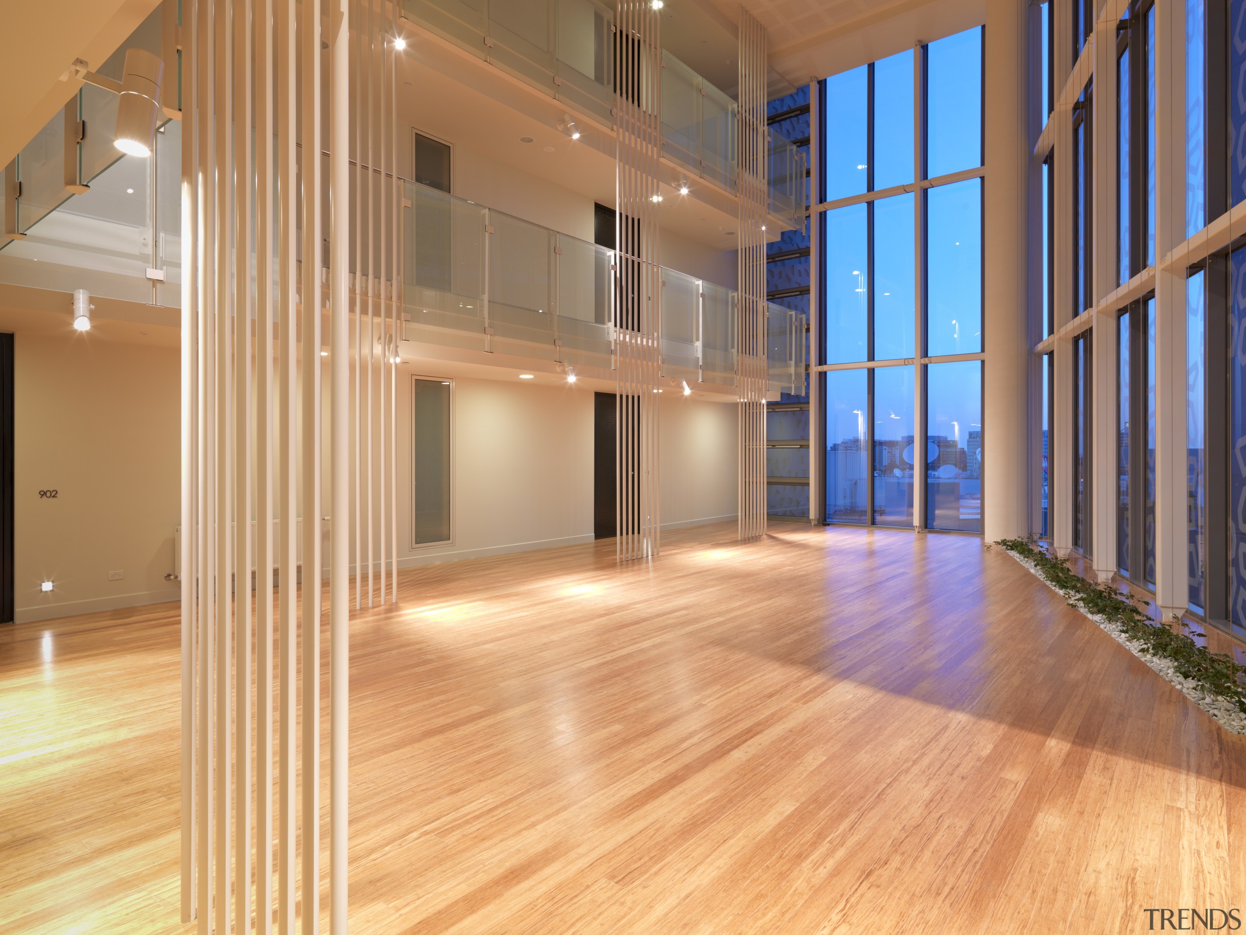 Interior view of the atrium of the Triptych apartment, architecture, daylighting, estate, floor, flooring, hardwood, home, house, interior design, laminate flooring, lobby, loft, real estate, structure, wood, wood flooring, orange