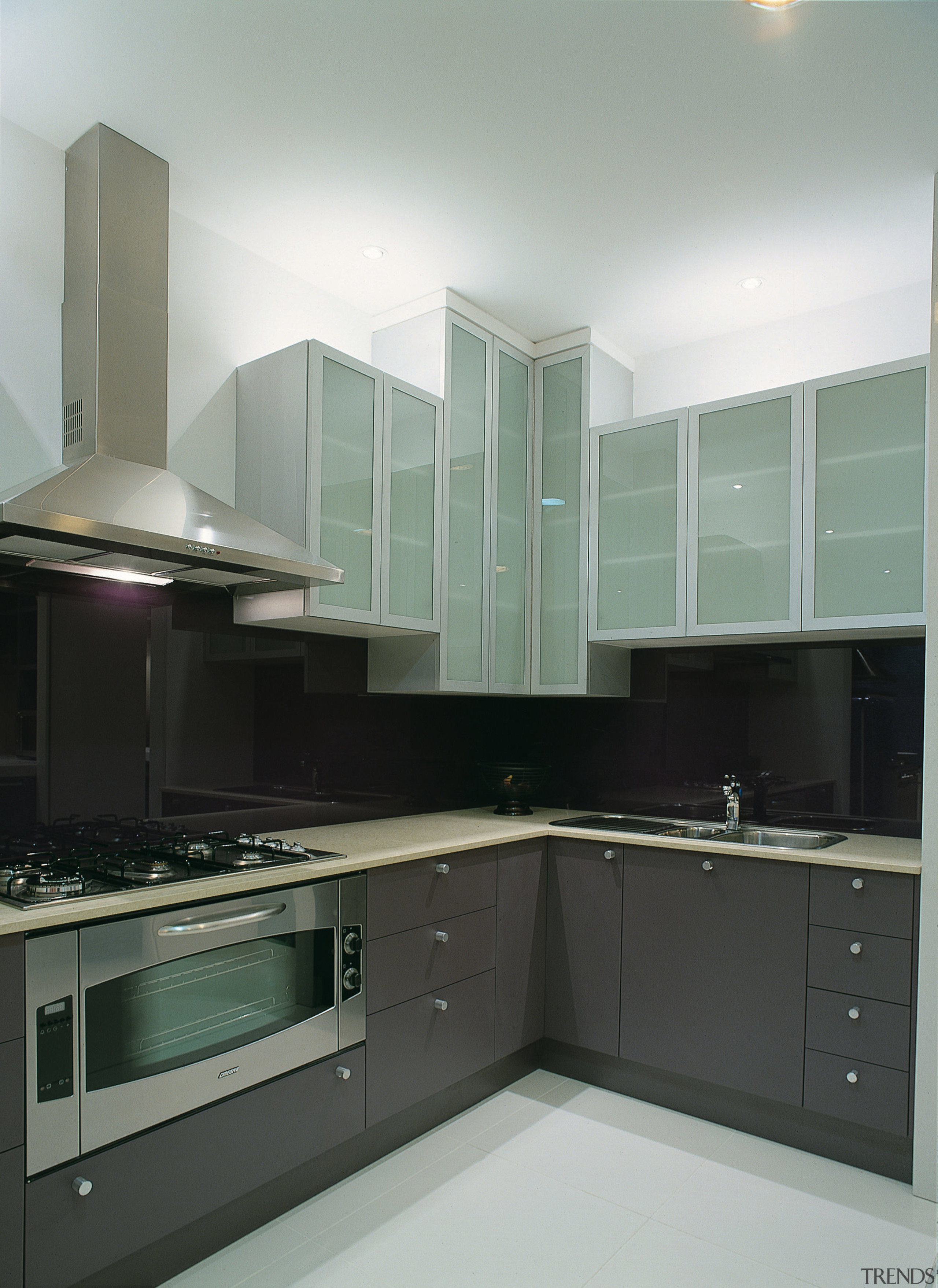 A view of a kitchen, white tile dfloor, cabinetry, countertop, glass, interior design, kitchen, room, gray, black