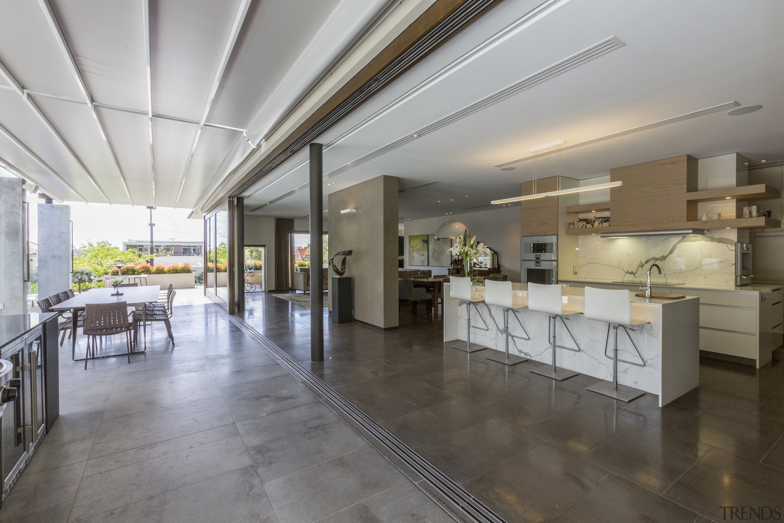 In this kitchen, the marble island front and ceiling, floor, flooring, interior design, real estate, gray