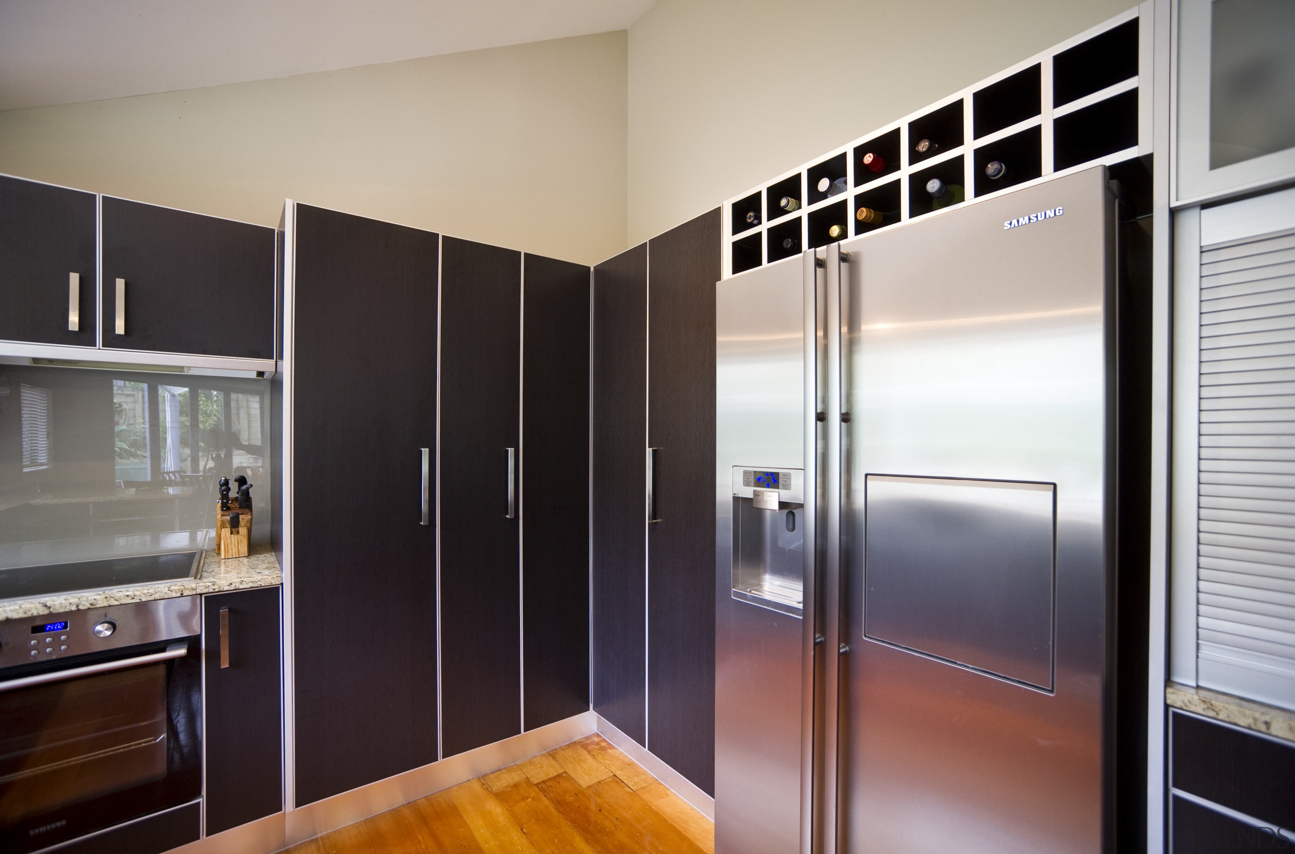 View of the contemporary kitchen - View of cabinetry, countertop, floor, home appliance, interior design, kitchen, real estate, refrigerator, room, gray, black