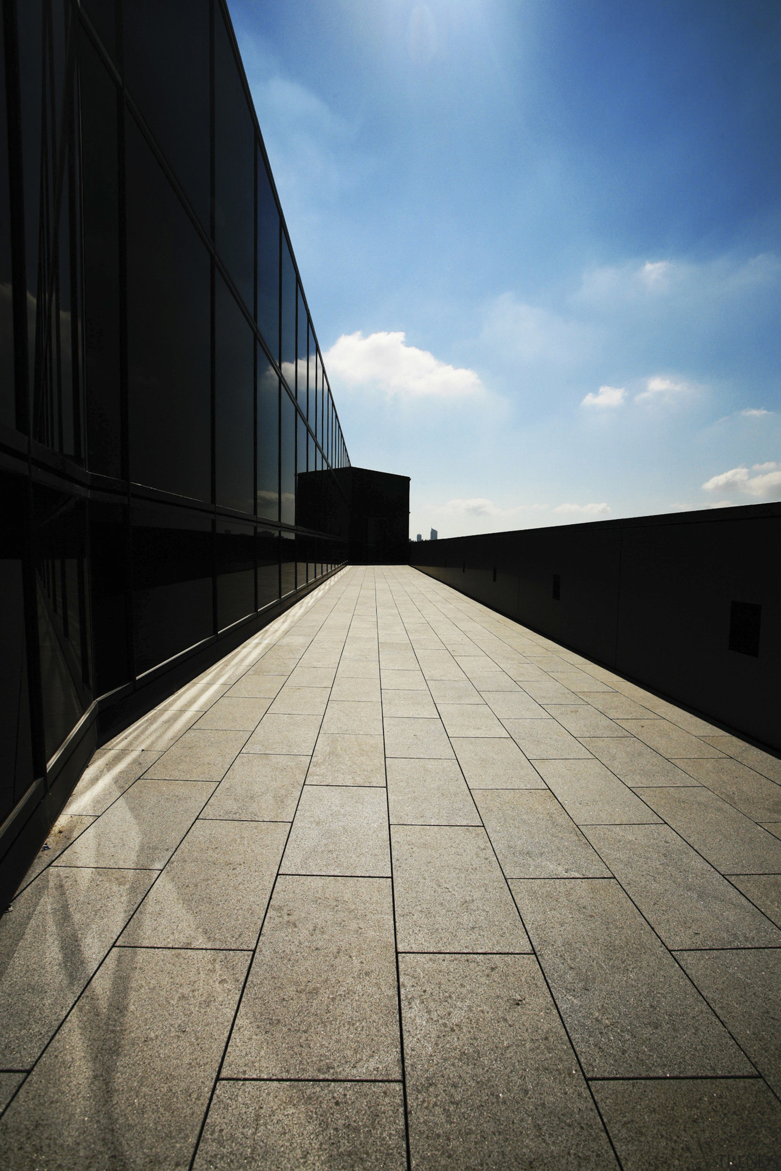 Image featuring paving done by Sam the Paving angle, architecture, atmosphere, building, cloud, daylighting, daytime, fixed link, horizon, infrastructure, landmark, line, reflection, road surface, sky, structure, sunlight, symmetry, wall, black, gray