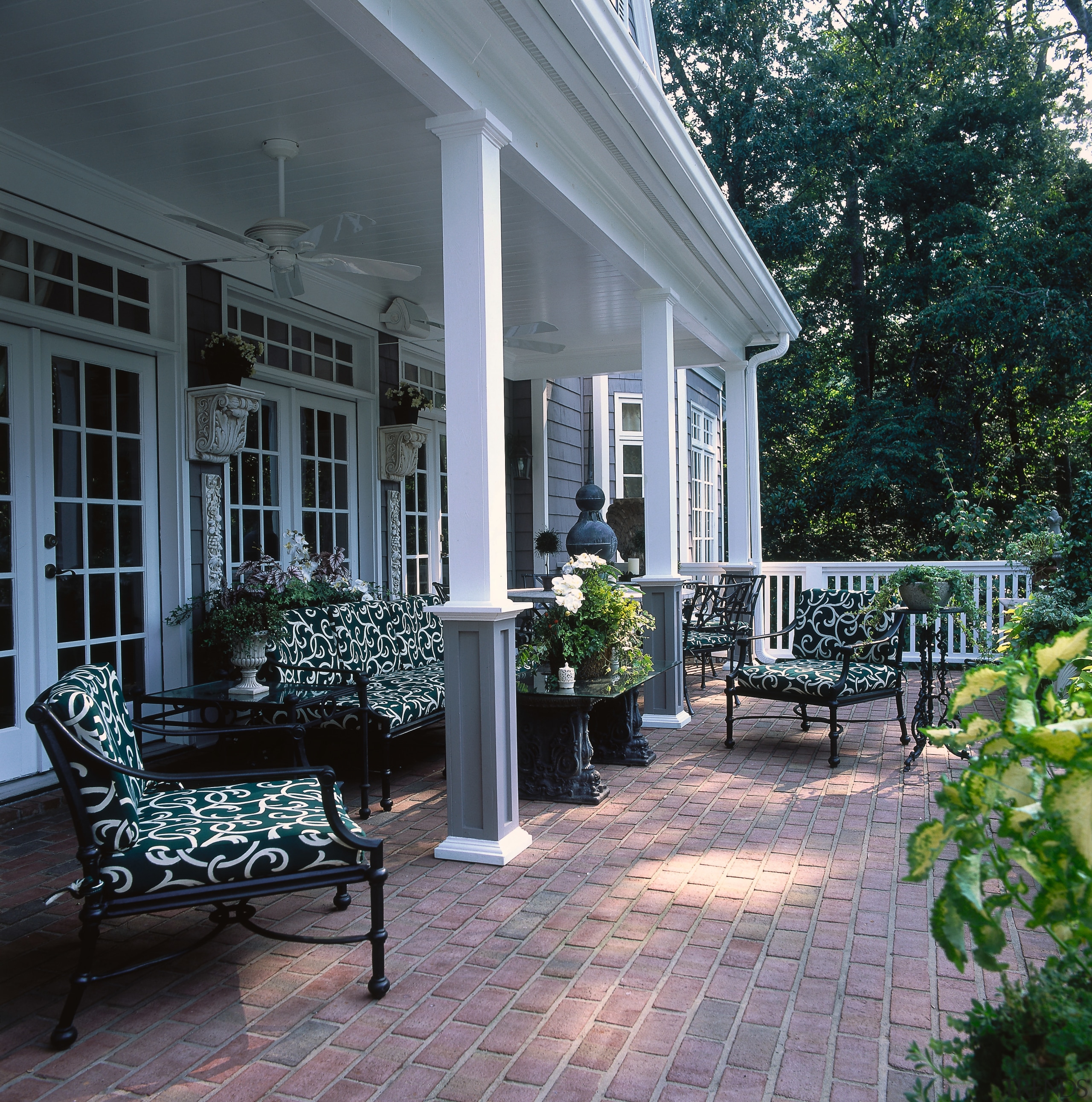 An exterior view of the patio area, brick backyard, courtyard, home, house, landscaping, outdoor structure, patio, porch, real estate, siding, walkway, window, yard, black, gray