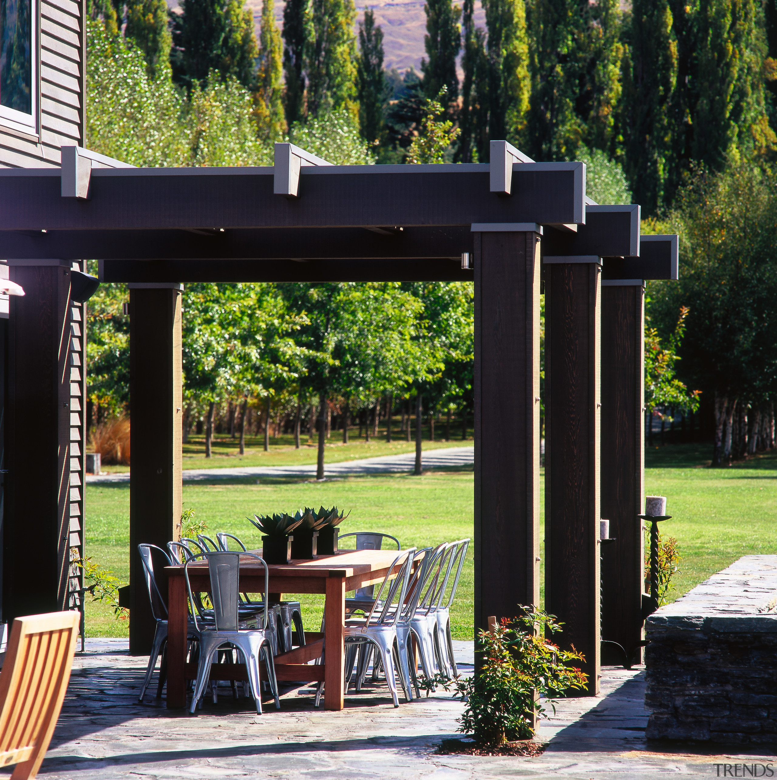 A view of the patio area, stone ground outdoor structure, pavilion, pergola, black