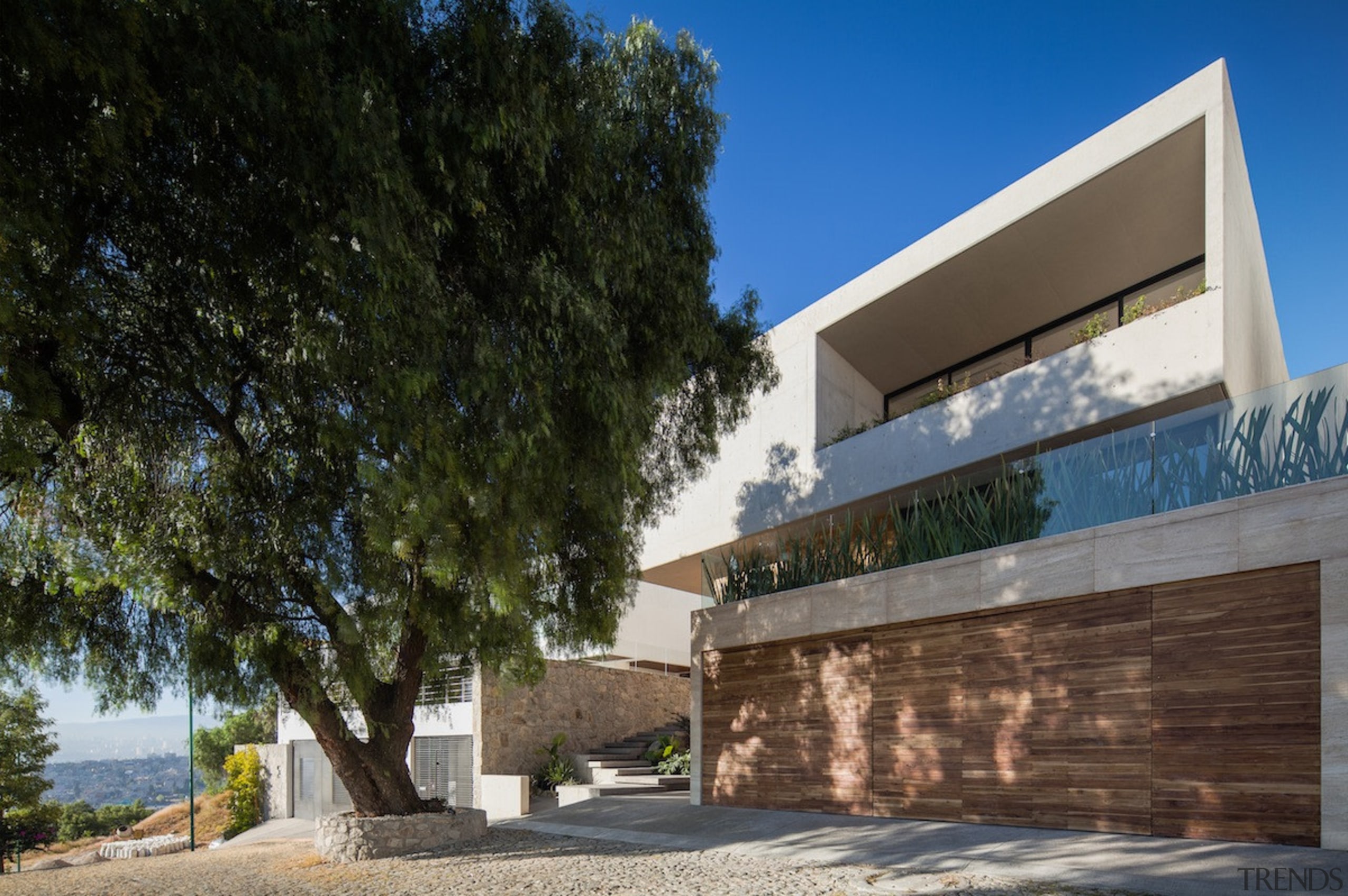 From the front, the home has a private architecture, building, facade, home, house, property, real estate, residential area, sky, tree, black