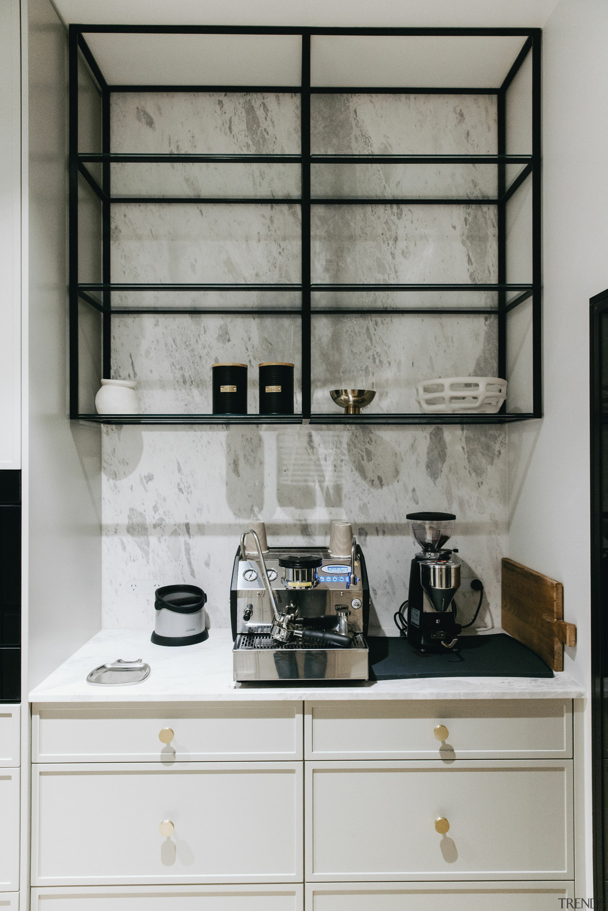 Custom black aluminium framed glass shelves sit above 