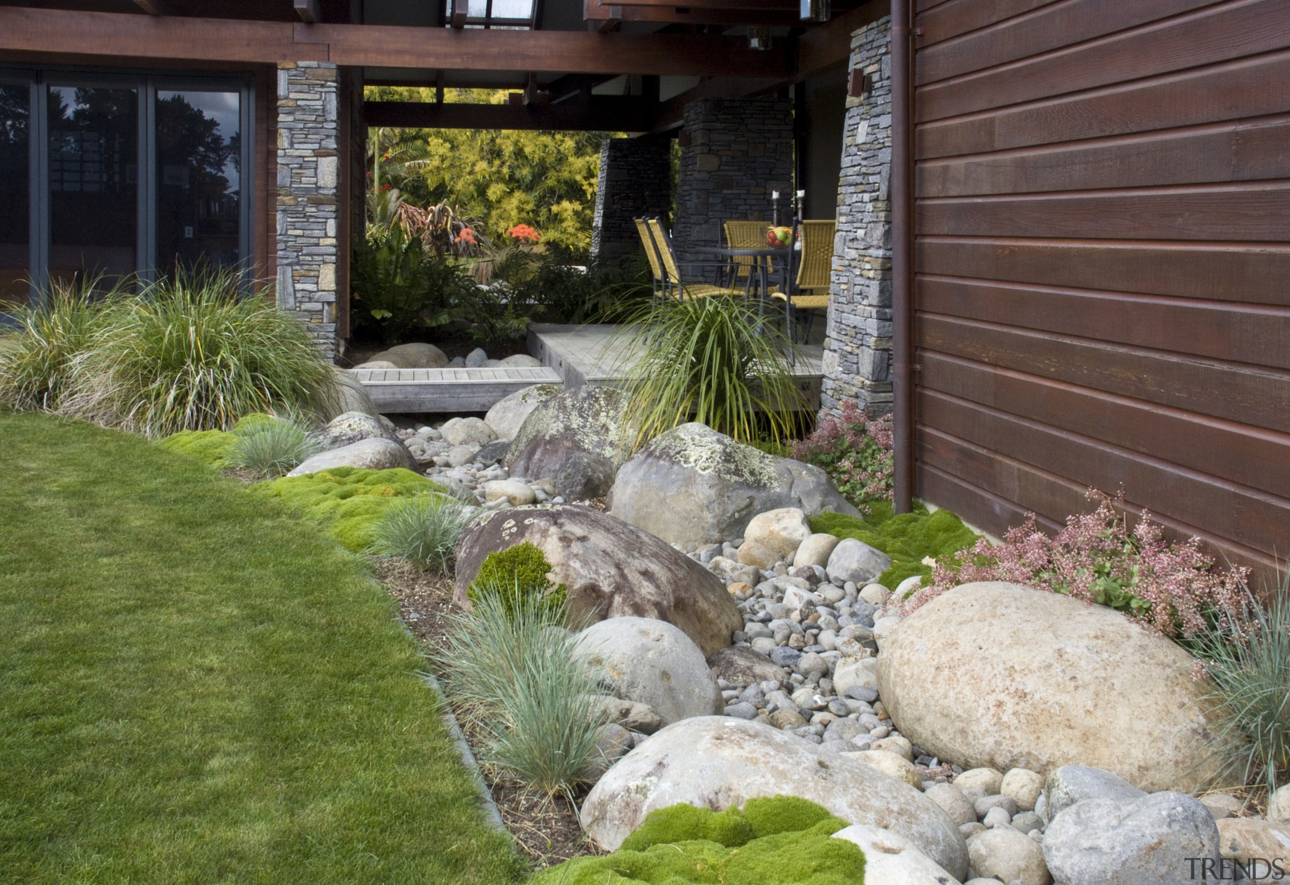 View of the rear of the house where backyard, garden, grass, landscape, landscaping, lawn, outdoor structure, plant, pond, walkway, yard, gray