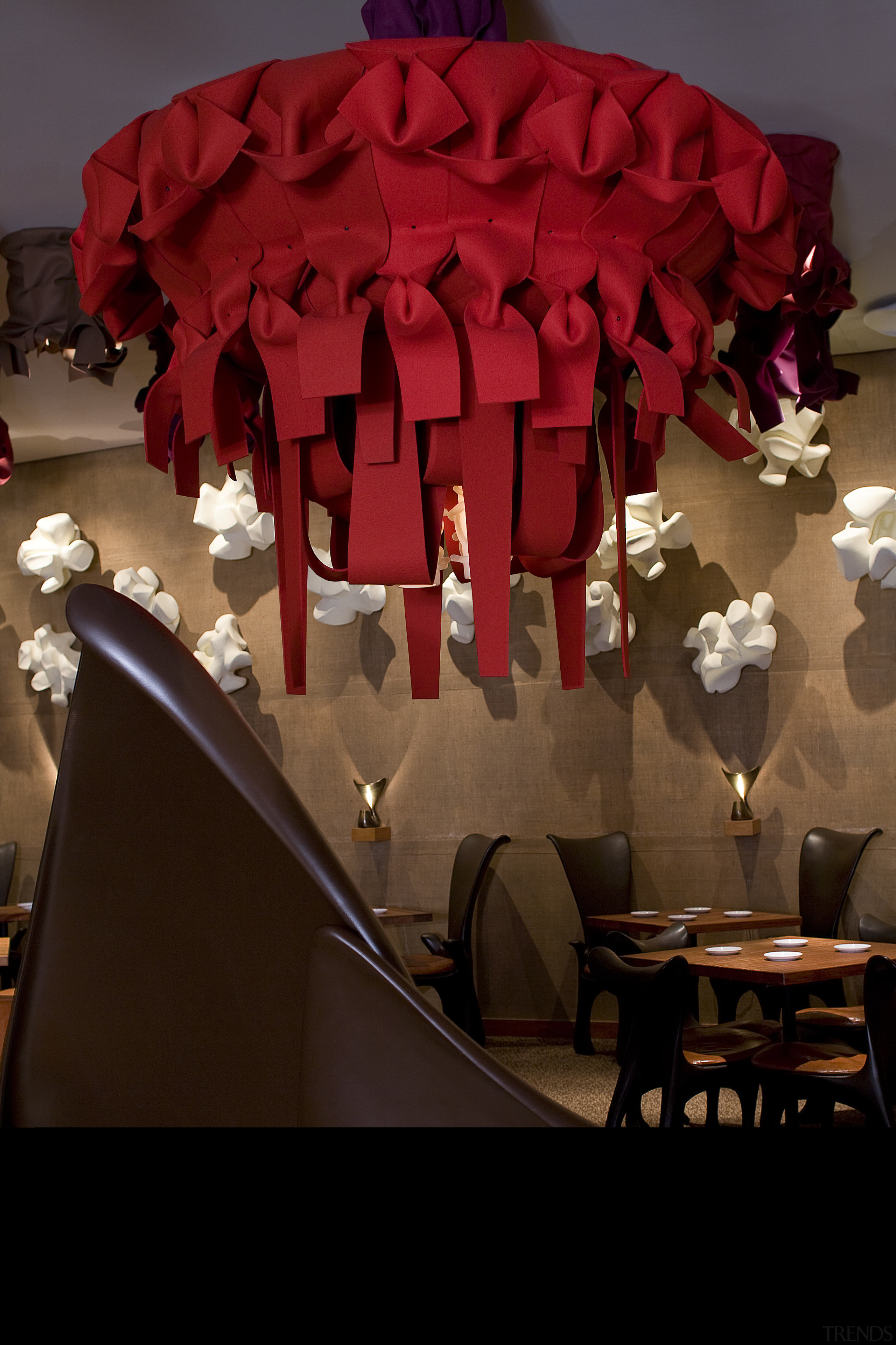 The large red Rasta chandelier in the Américas centrepiece, floristry, flower, interior design, lampshade, light fixture, lighting, lighting accessory, petal, red, restaurant, red, brown