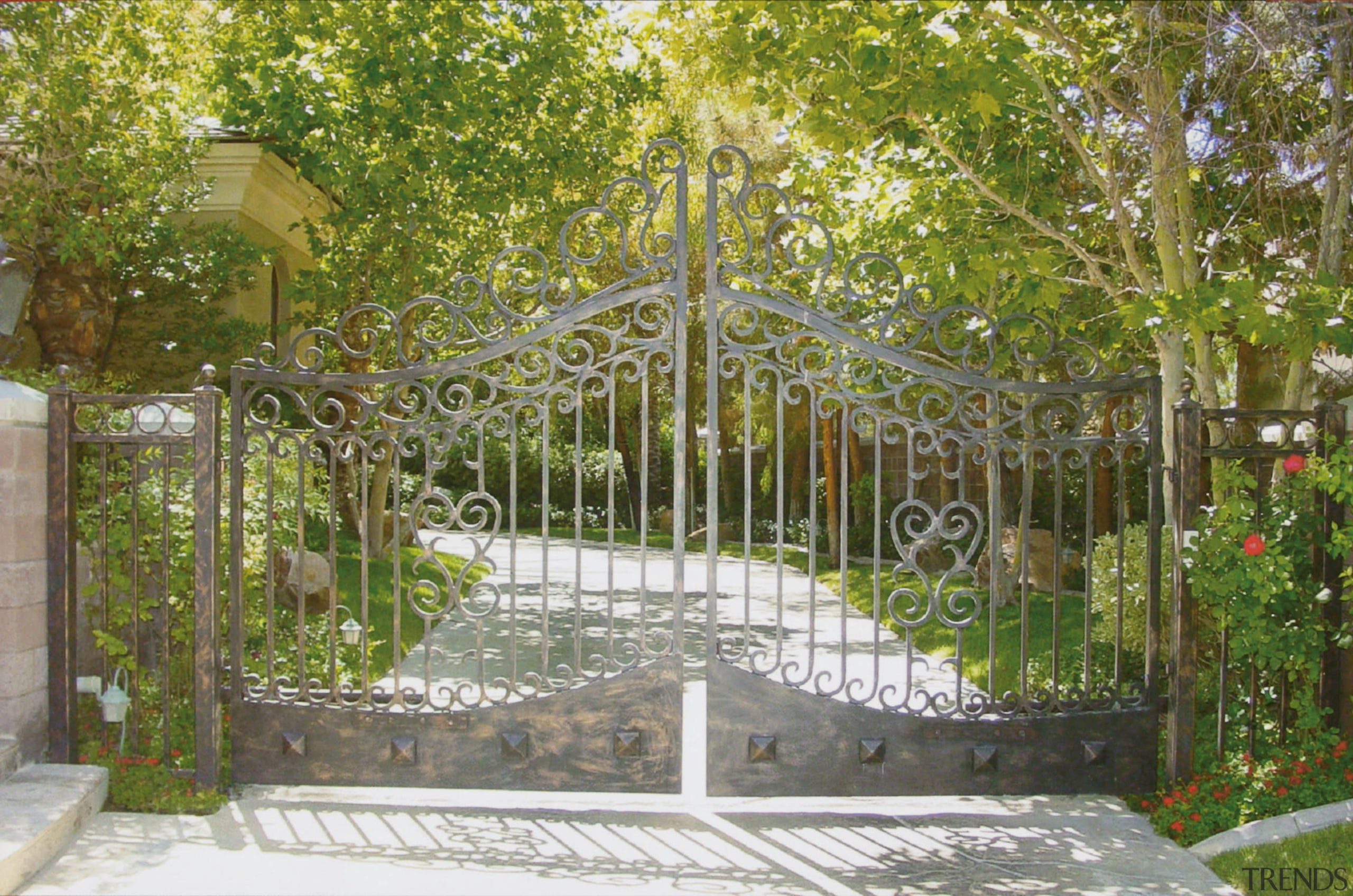 View of a driveway with a very large courtyard, estate, fence, garden, gate, home fencing, iron, outdoor structure, brown, gray