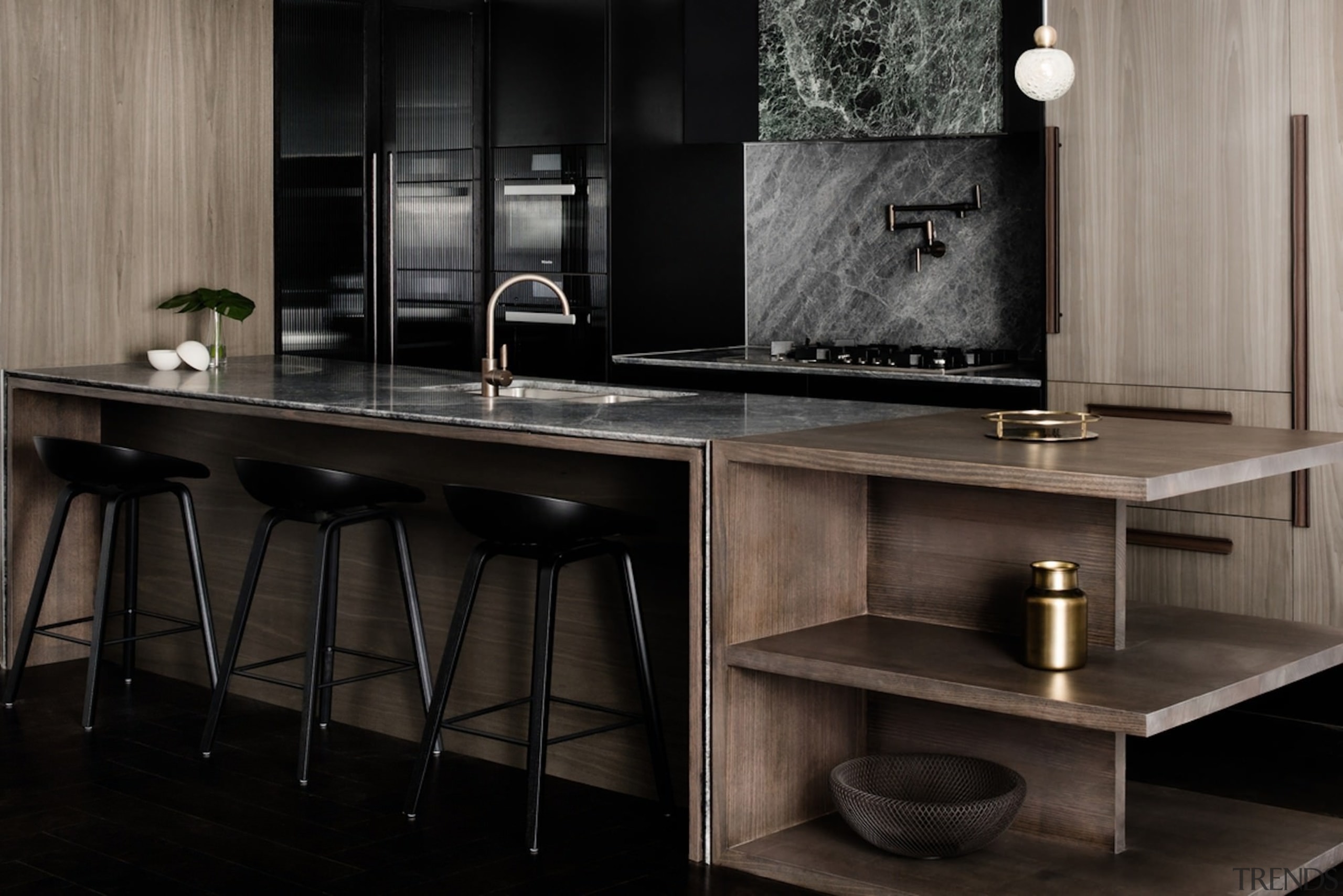 This island is perfect for an apartment, featuring cabinetry, countertop, floor, flooring, furniture, interior design, kitchen, sink, table, black, gray