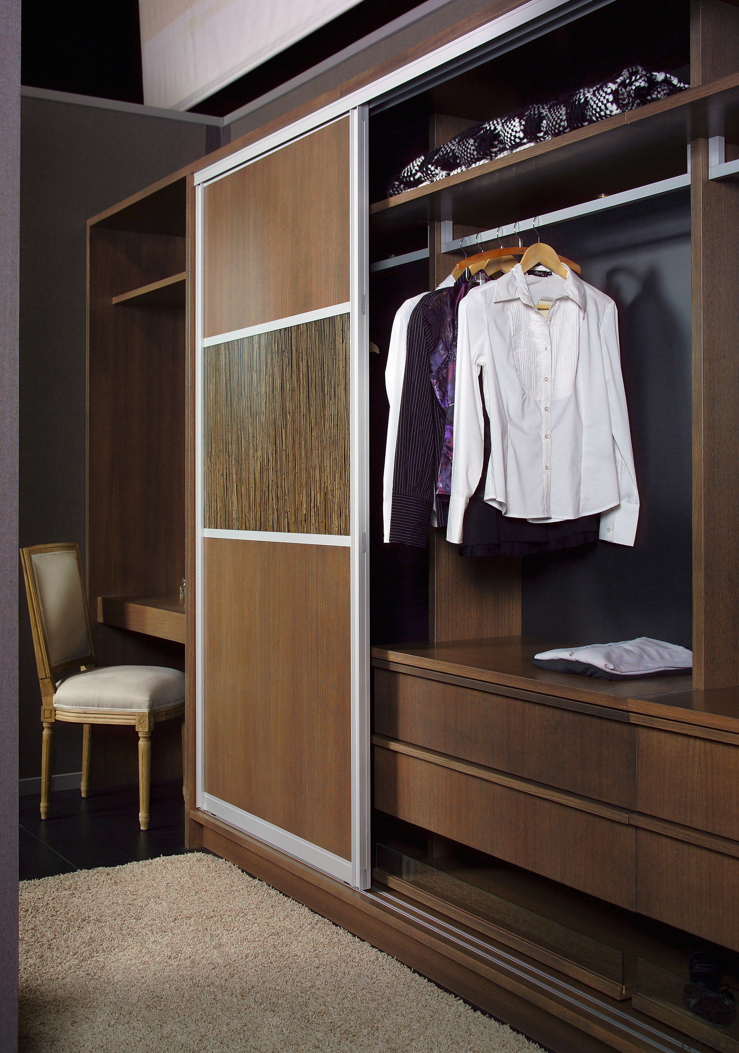 A view of the Walk in wardrobe featuring cabinetry, closet, furniture, room, wardrobe, black